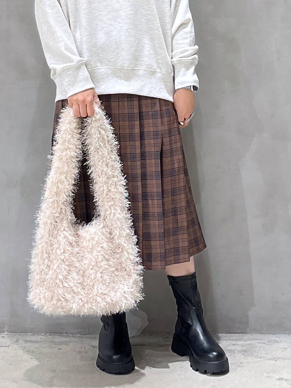 ブラック系のブーツ、ベージュ系のショルダーバッグ、ベージュ系のスウェットを着用したレディースの秋コーディネートの6枚目の写真