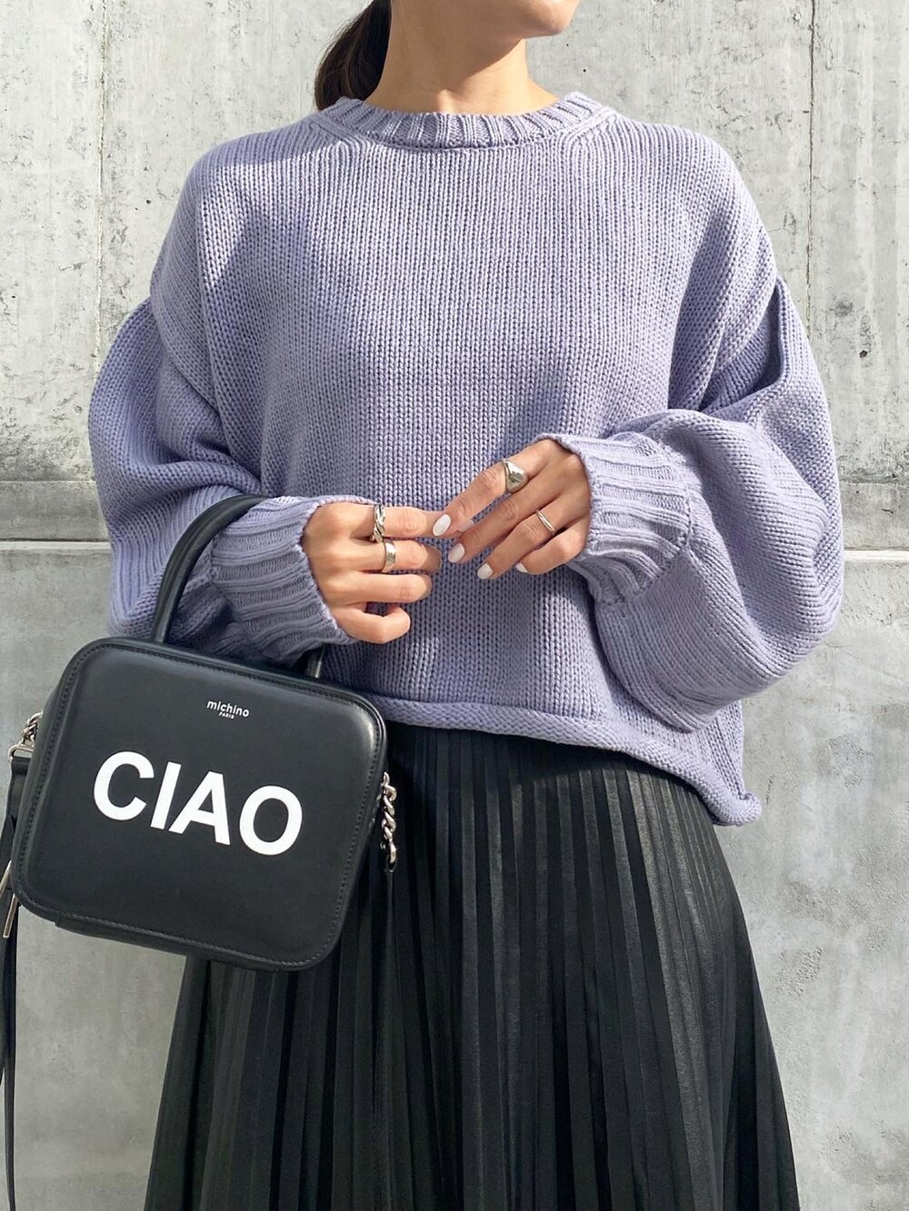 ブラック系のバッグ、ブラック系のスカート、ブラック系のスニーカーを着用したレディースの秋コーディネートの4枚目の写真