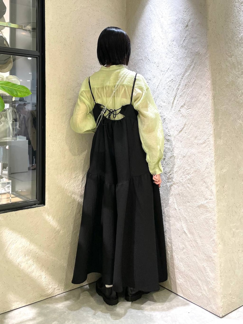 ブラック系のモカシン/デッキシューズ、ブラック系のワンピース、その他のショルダーバッグを着用したレディースの春コーディネートの2枚目の写真