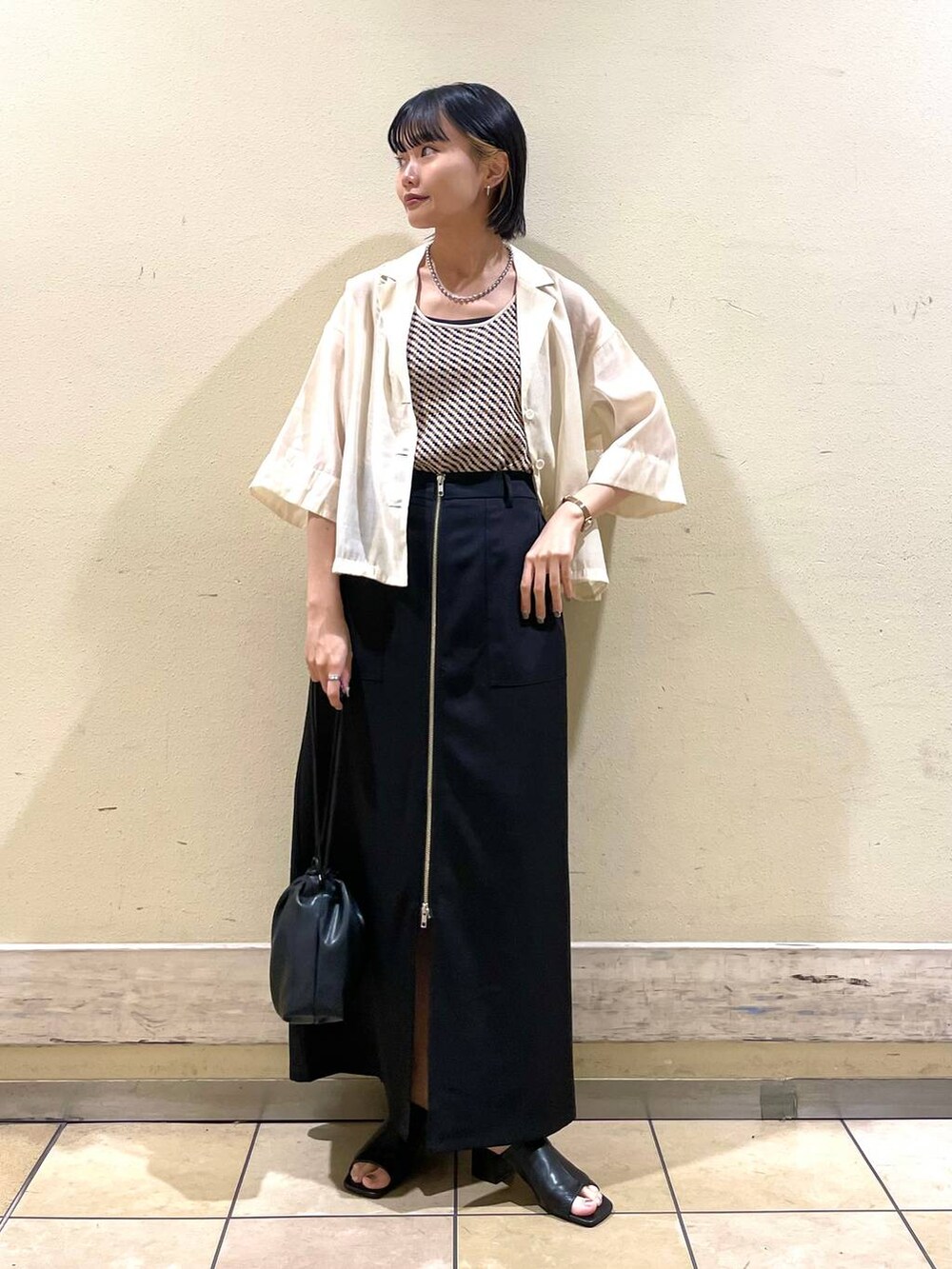 ホワイト系のシャツ/ブラウス、ブラック系のサンダル、ホワイト系のTシャツ/カットソーを着用したレディースの夏コーディネートの3枚目の写真