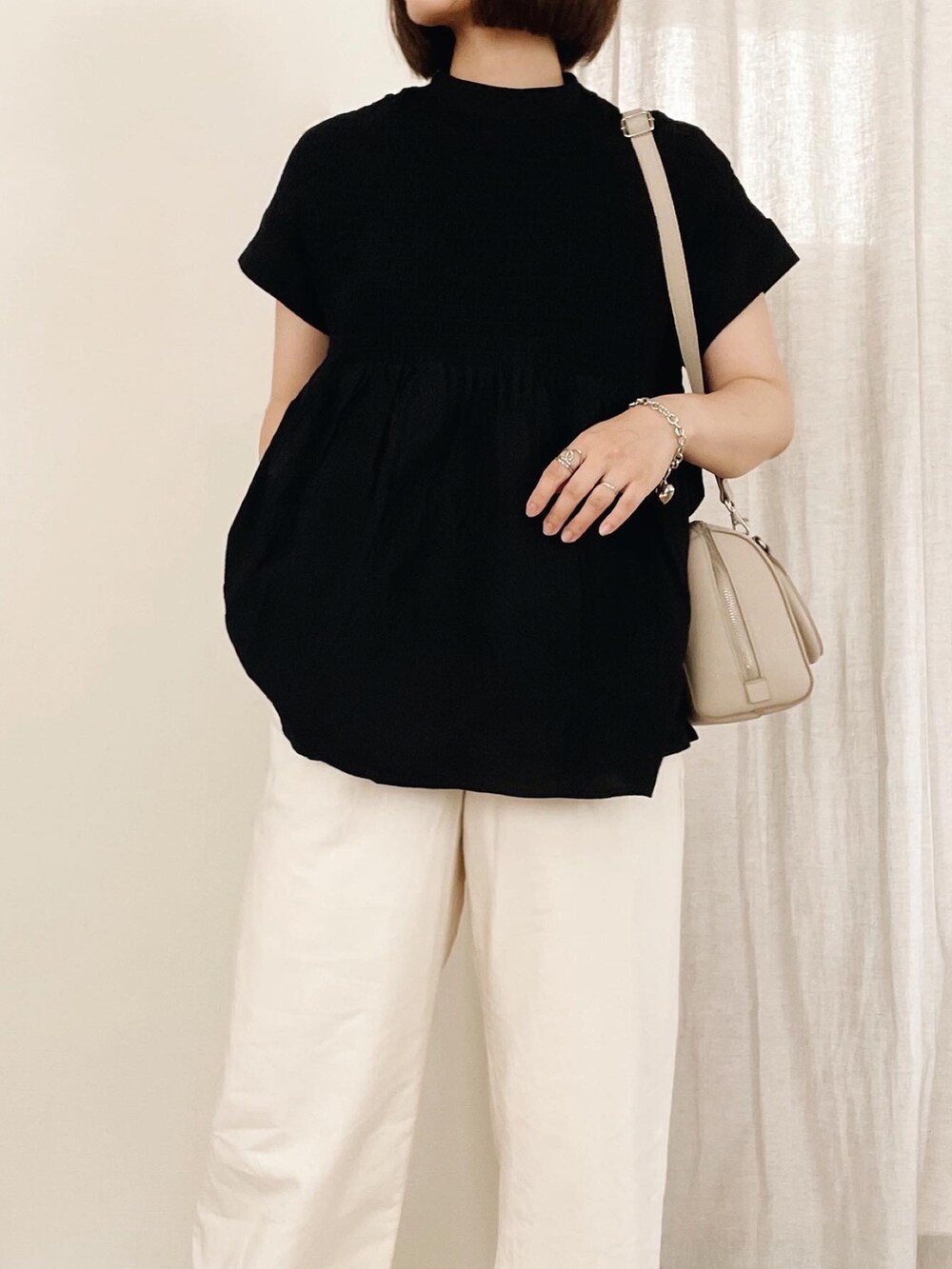 ブラック系のシャツ/ブラウス、ホワイト系のサンダルを着用したレディースの夏コーディネートの2枚目の写真