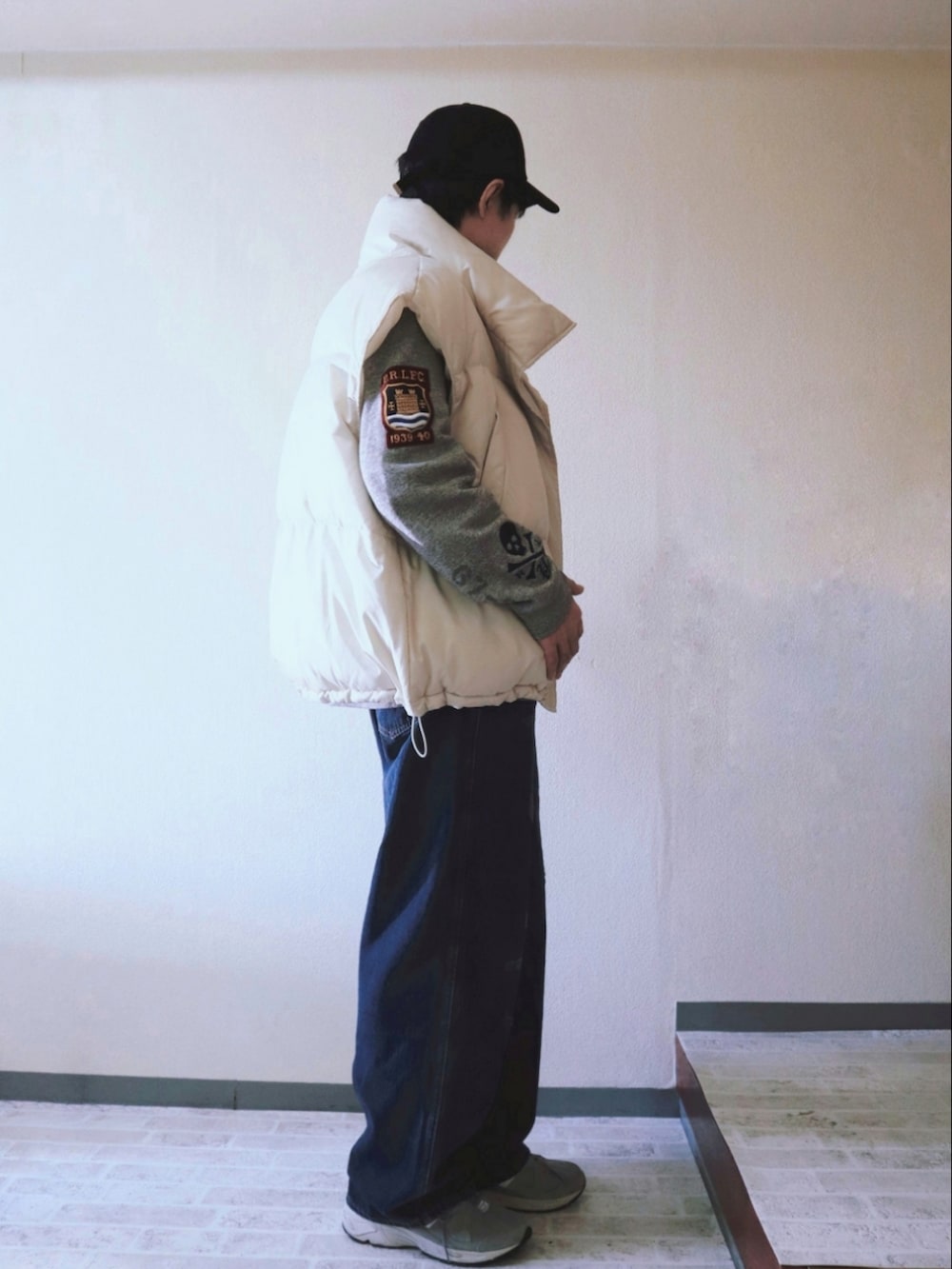 ブルー系のデニムパンツ、グレー系のスウェット、ベージュ系のボディバッグ/ウエストポーチを着用したメンズの春コーディネートの2枚目の写真