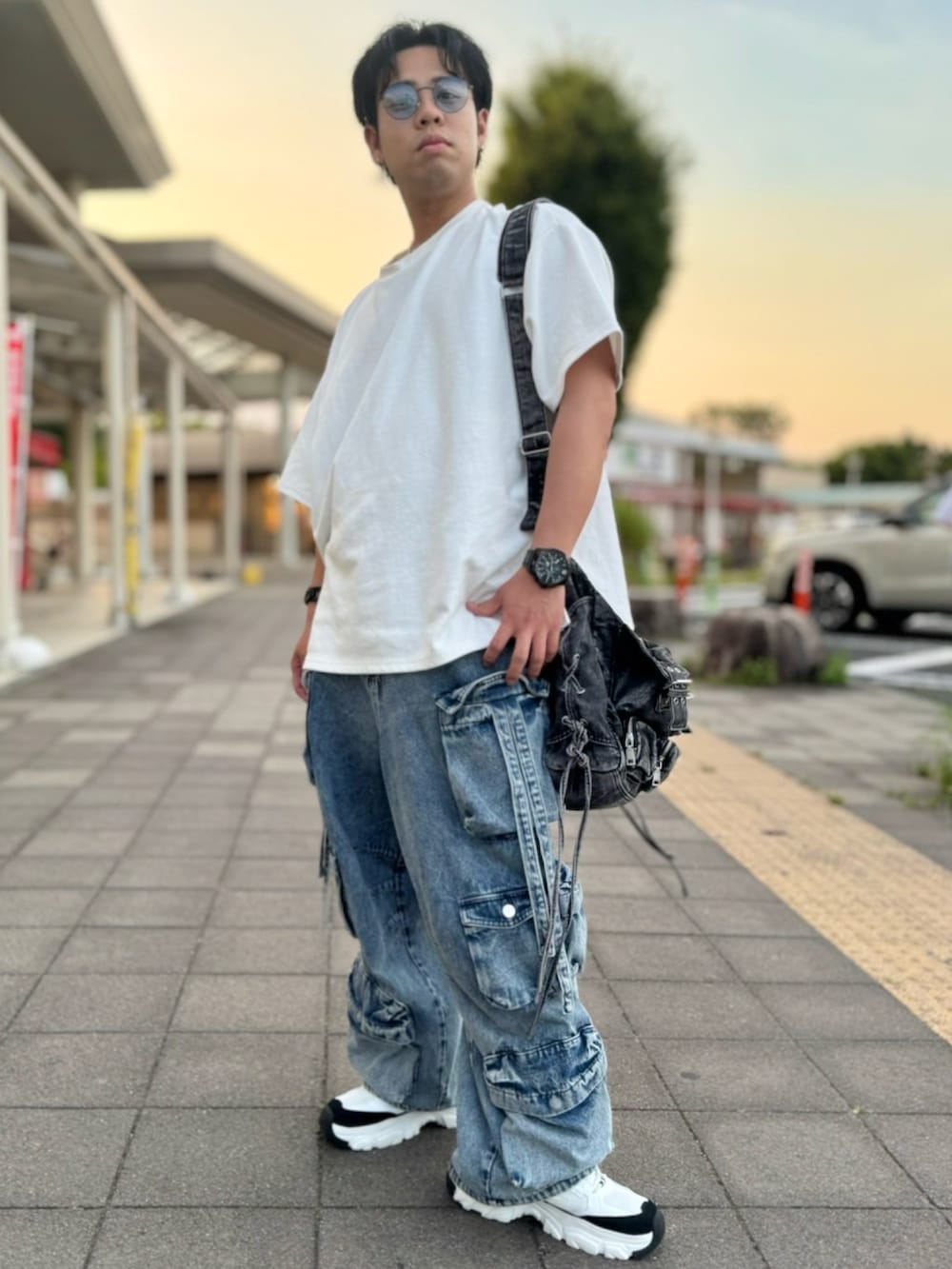 ホワイト系のTシャツ/カットソー、ブルー系のカーゴパンツ、ブラック系のショルダーバッグを着用したメンズの夏コーディネートの2枚目の写真