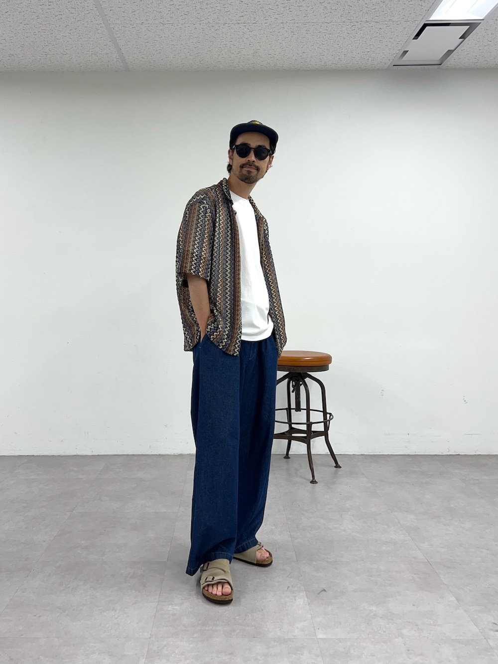 ブラウン系のシャツ/ブラウス、ブルー系のデニムパンツを着用したメンズの夏コーディネートの2枚目の写真