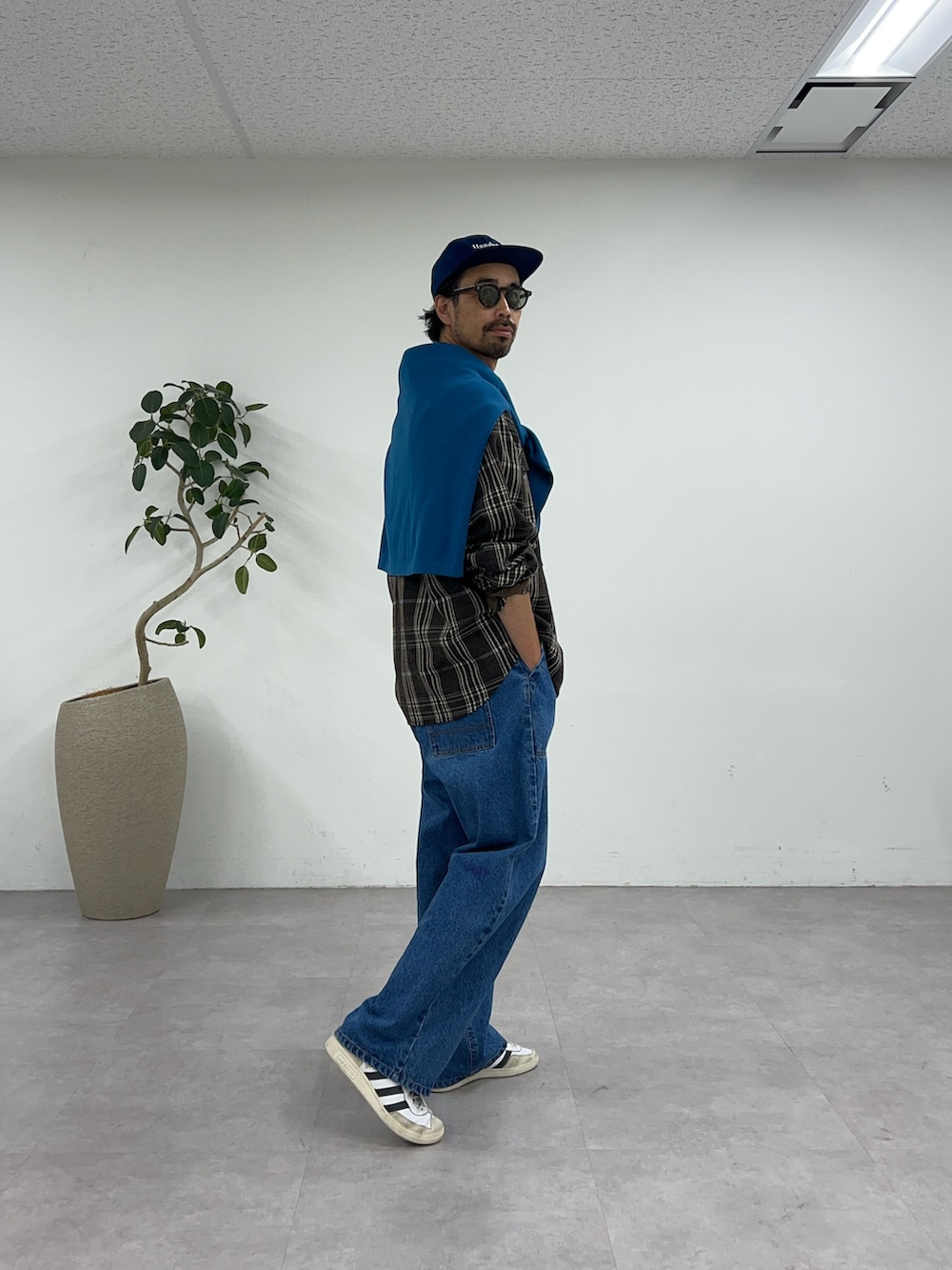 ブラウン系のシャツ/ブラウス、ブルー系のデニムパンツ、ブルー系のキャップを着用したメンズの夏コーディネートの2枚目の写真