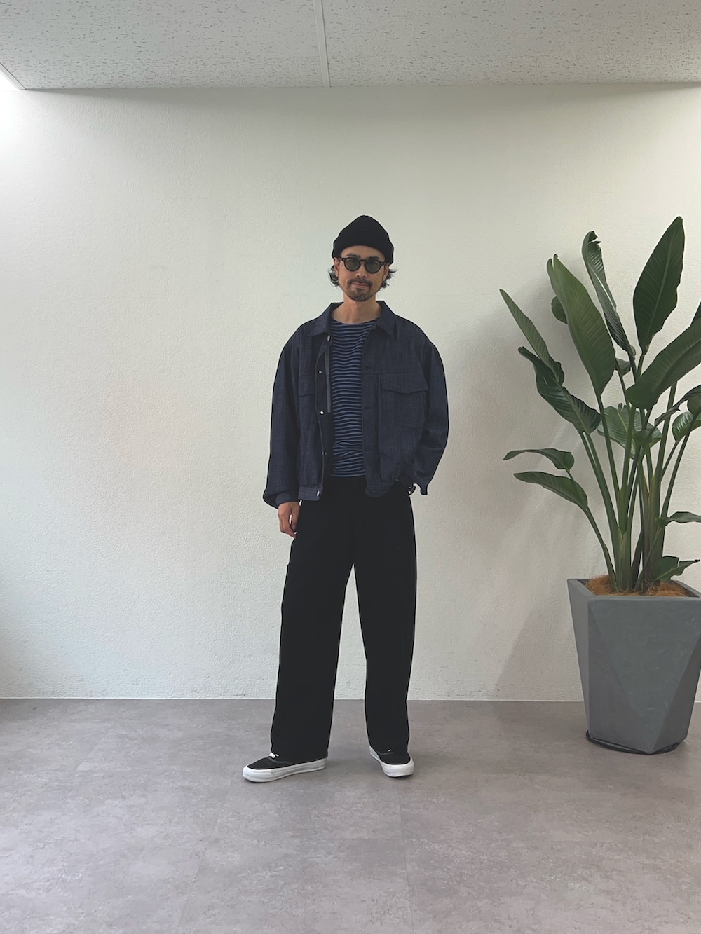 ブルー系のデニムジャケット、ブラック系のデニムパンツ、ブラック系のニットキャップ/ビーニーを着用したメンズの秋コーディネートの2枚目の写真
