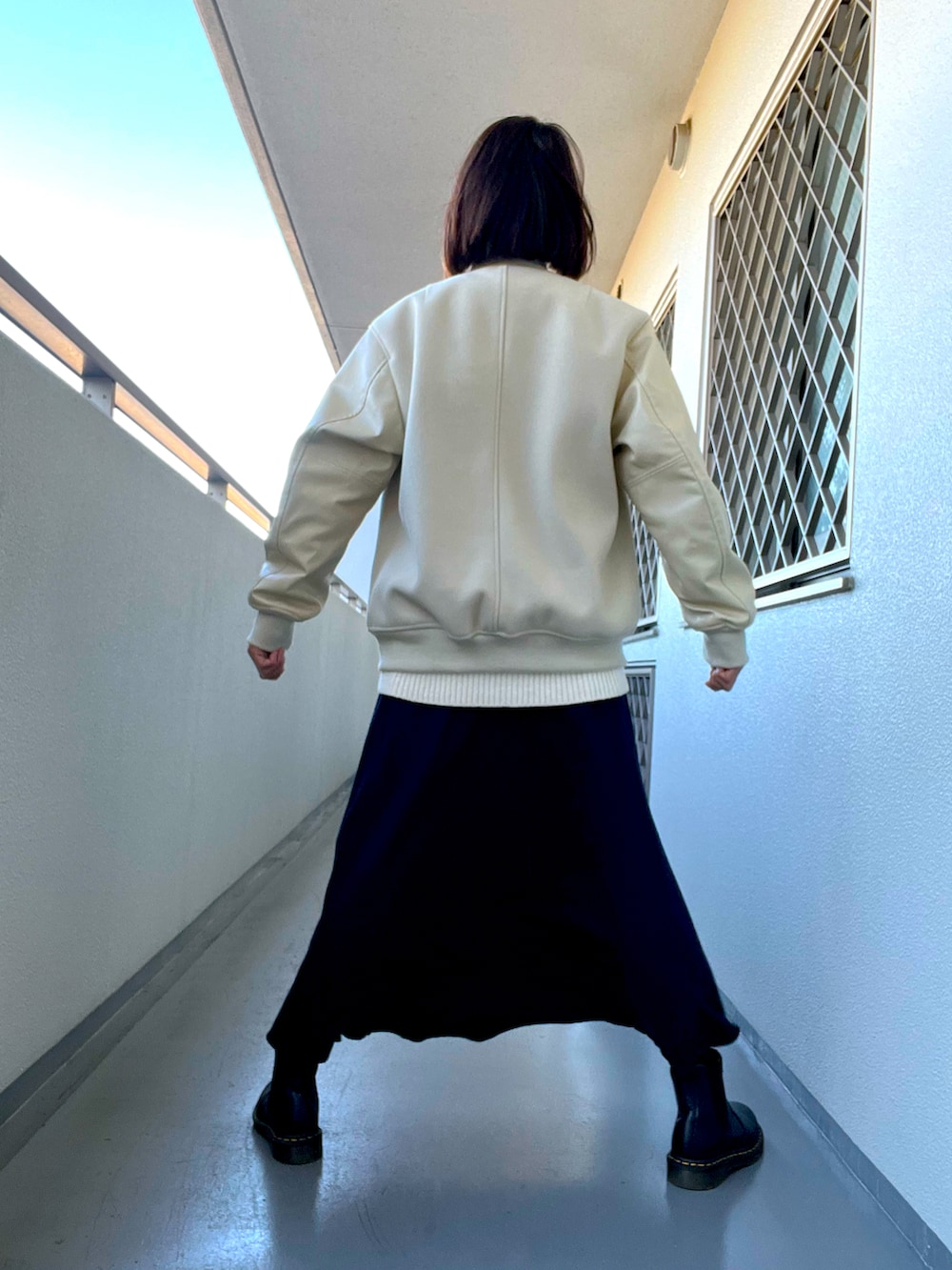 その他のスカート、ブラック系のブーツ、ホワイト系のTシャツ/カットソーを着用したレディースの冬コーディネートの4枚目の写真