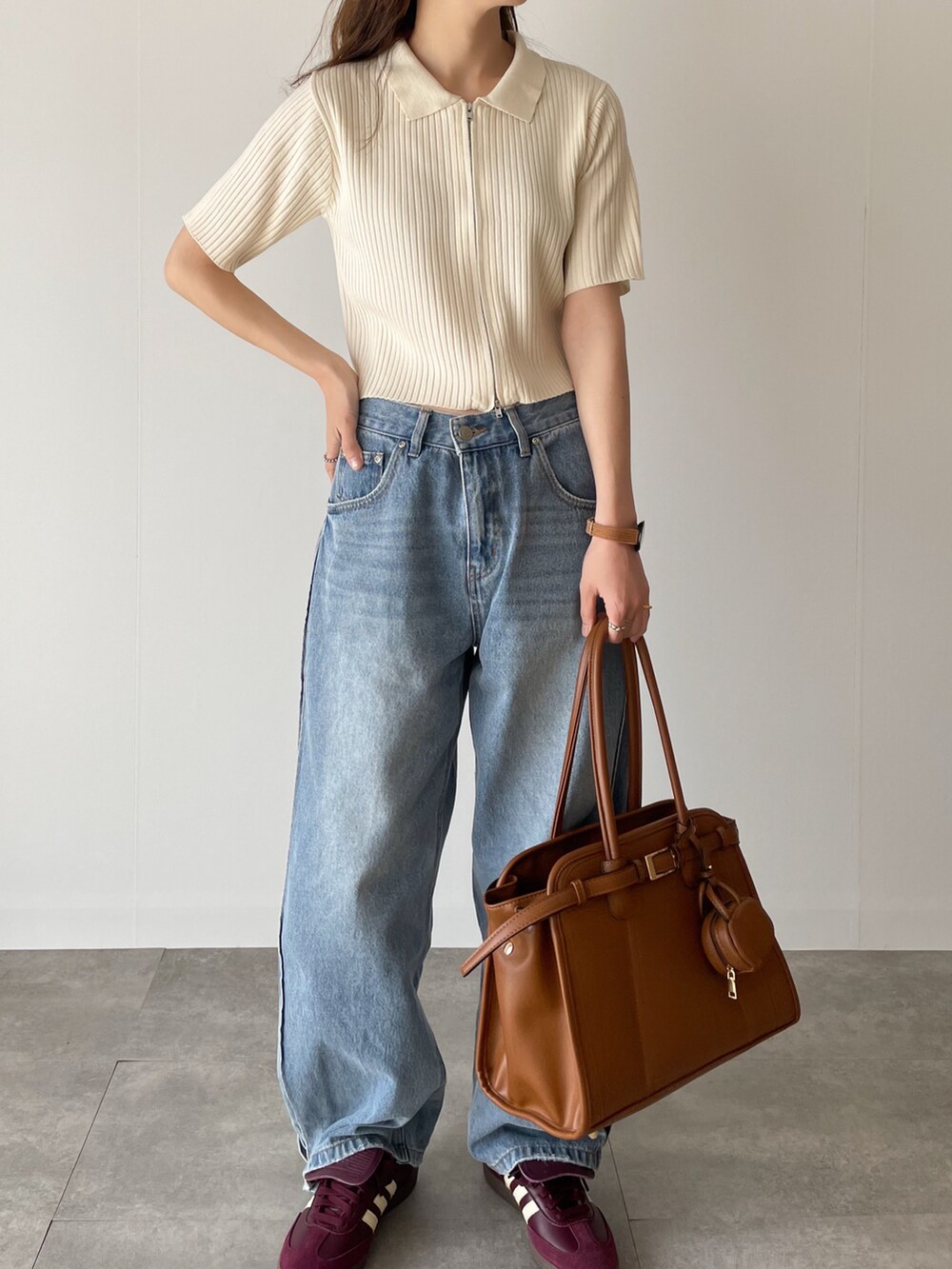 ホワイト系のニット/セーター、レッド系のスニーカーを着用したレディースの春コーディネートの2枚目の写真