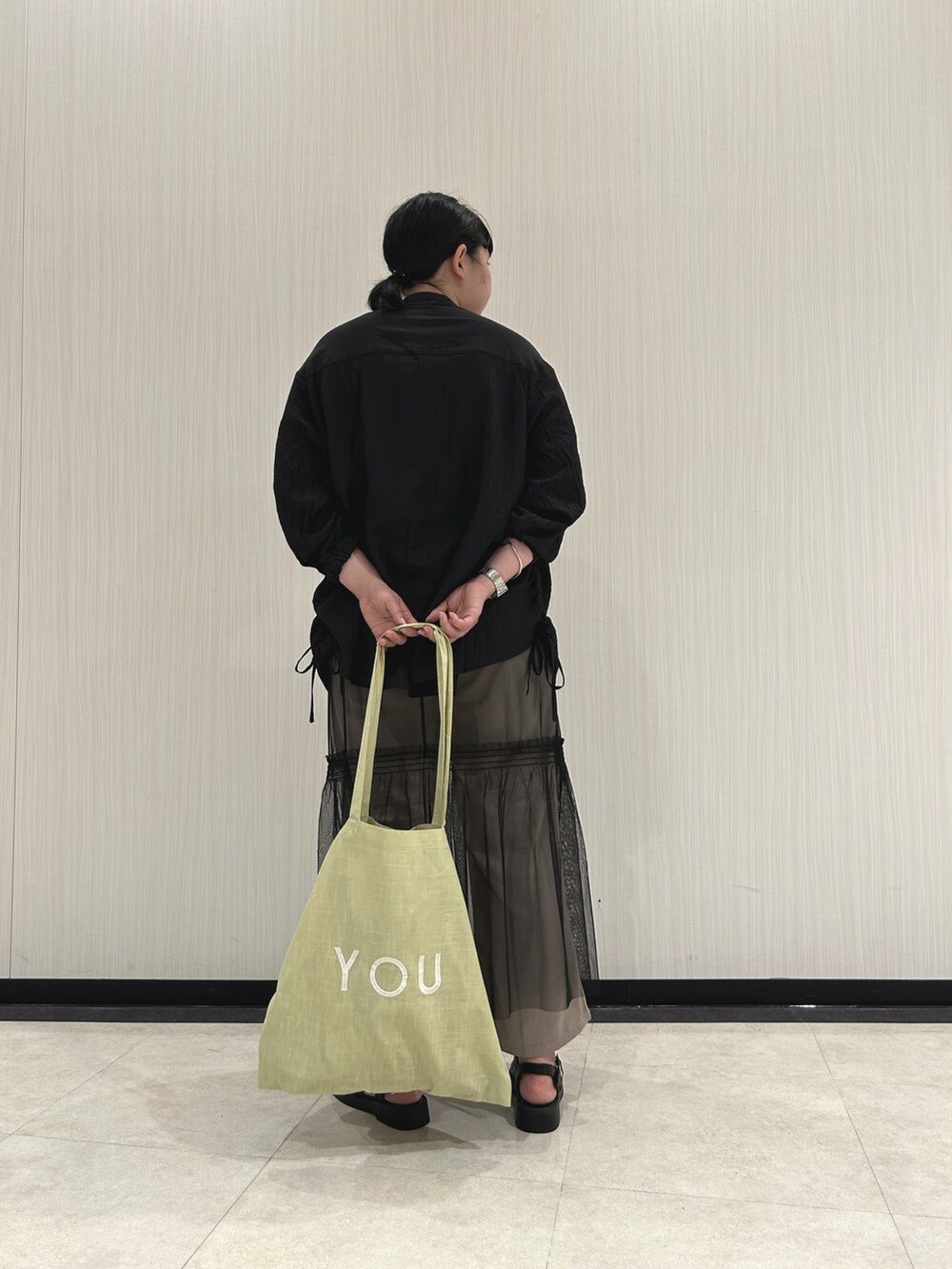 ブラック系のシャツ/ブラウス、ブラック系のスカート、ベージュ系のその他パンツを着用したレディースの春コーディネートの4枚目の写真