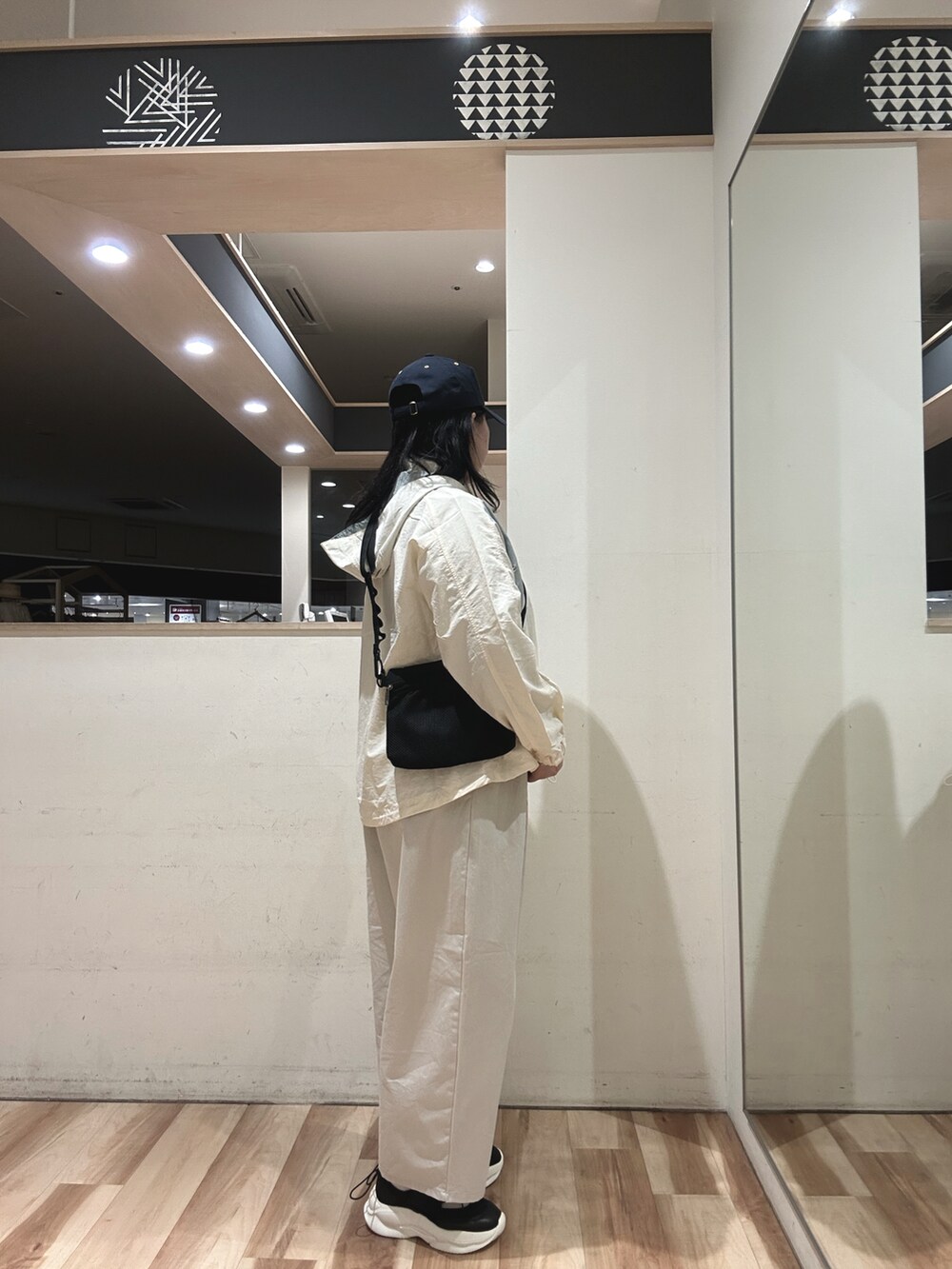 ホワイト系のその他パンツ、ブラック系のスニーカー、ホワイト系のブルゾンを着用したレディースの春コーディネートの2枚目の写真