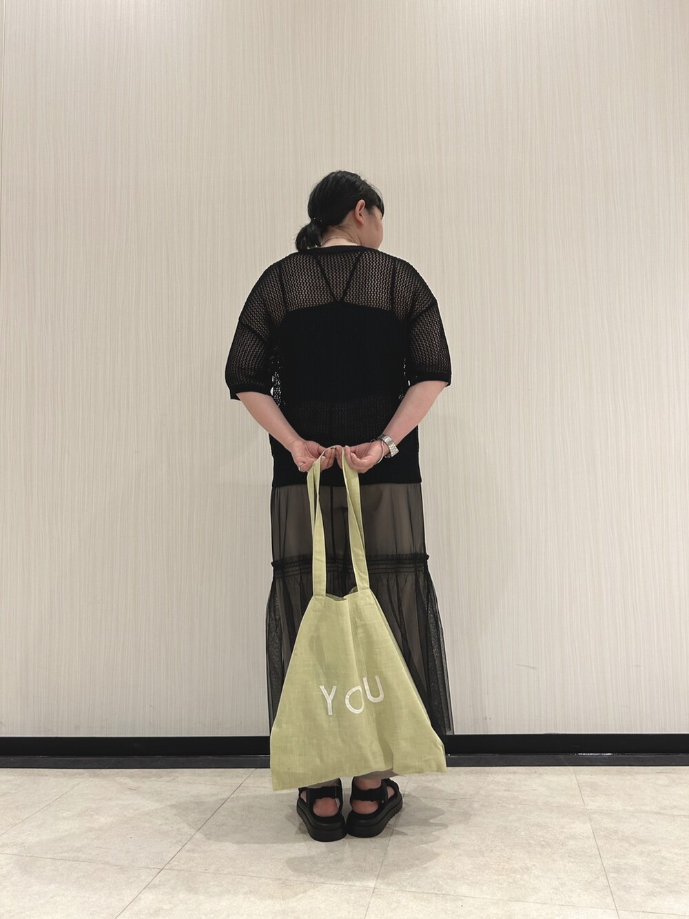 ブラック系のニット/セーター、ブラック系のスカート、ベージュ系のその他パンツを着用したレディースの春コーディネートの3枚目の写真