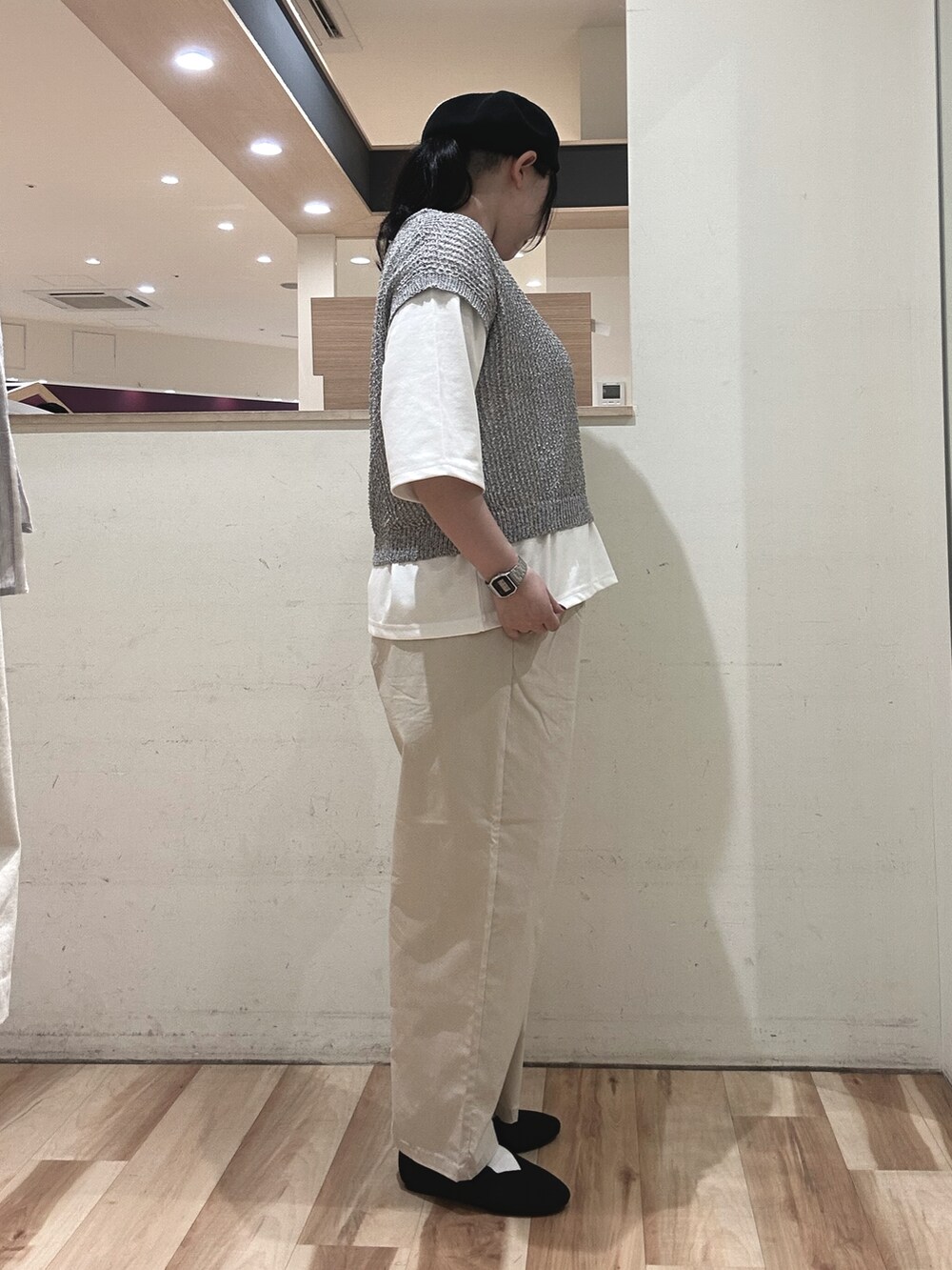 グレー系のニット/セーター、ホワイト系のTシャツ/カットソー、ベージュ系のその他パンツを着用したレディースの春コーディネートの2枚目の写真