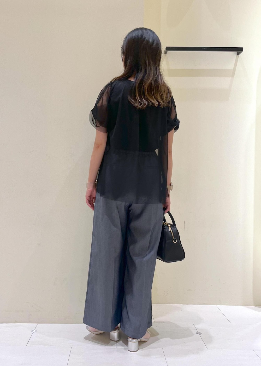 ブラック系のボストンバッグ、シルバー系のパンプス、ブラック系のTシャツ/カットソーを着用したレディースの夏コーディネートの4枚目の写真