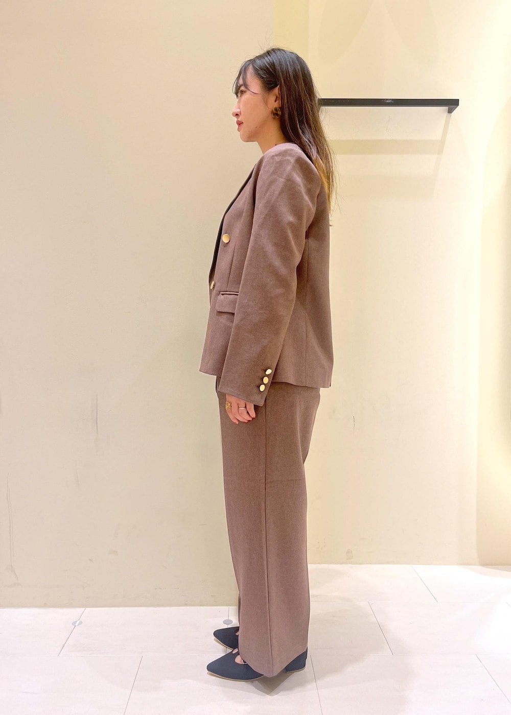 ブラック系のショルダーバッグ、ブラック系のシャツ/ブラウス、ベージュ系のテーラードジャケットを着用したレディースの秋コーディネートの4枚目の写真