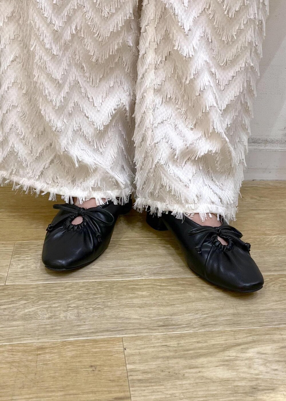 グレー系のタンクトップ、ブラック系のパンプス、イエロー系のショルダーバッグを着用したレディースの夏コーディネートの10枚目の写真