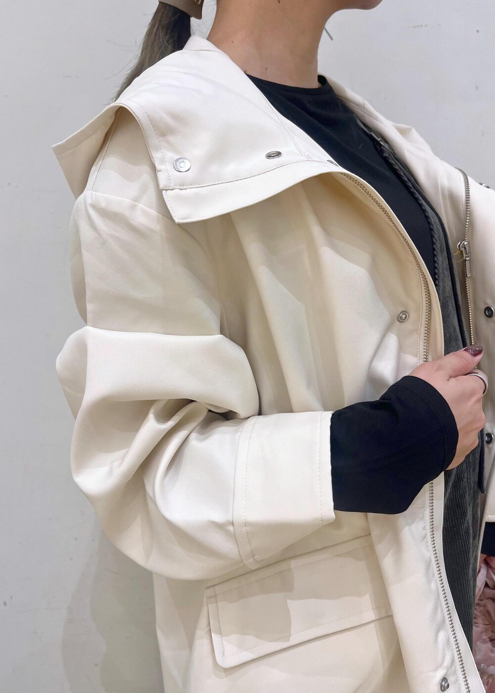 ブラック系のTシャツ/カットソー、ピンク系のショルダーバッグ、ホワイト系のマウンテンパーカーを着用したレディースの秋コーディネートの7枚目の写真