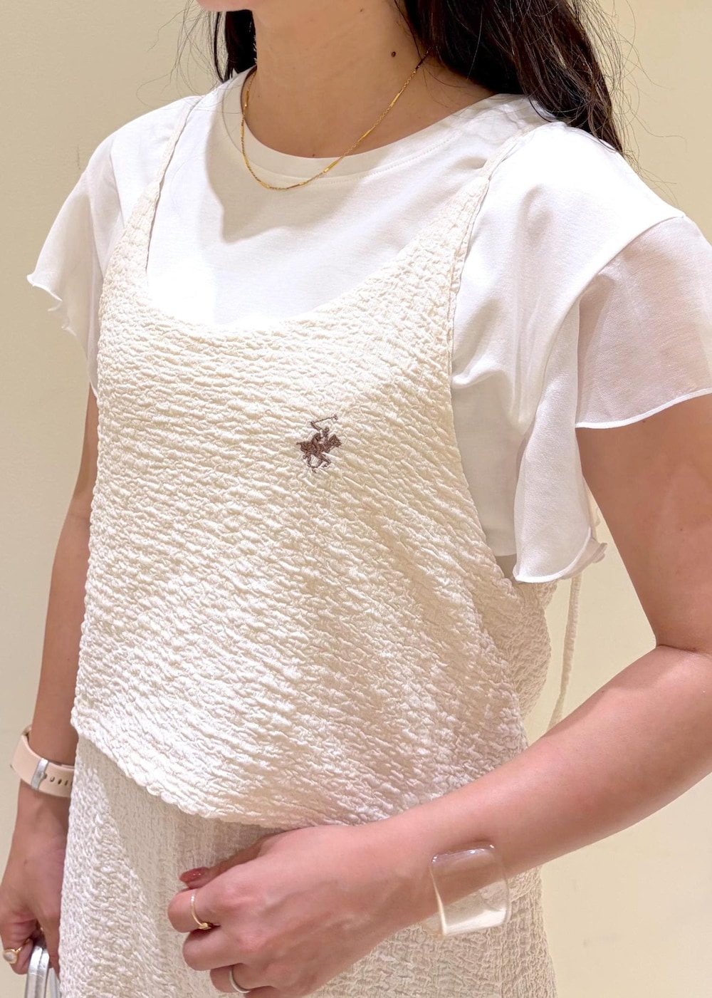 シルバー系のサンダル、シルバー系のトートバッグ、ホワイト系のTシャツ/カットソーを着用したレディースの夏コーディネートの5枚目の写真