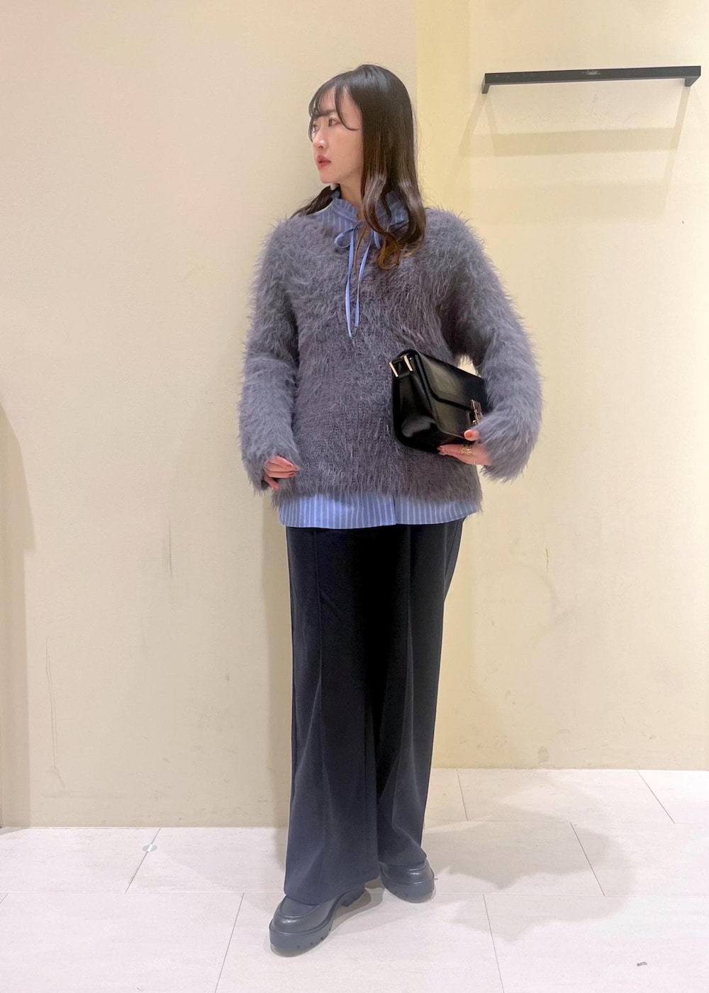 ブラック系のショルダーバッグ、ブルー系のその他パンツ、ブラック系のローファーを着用したレディースの冬コーディネートの2枚目の写真