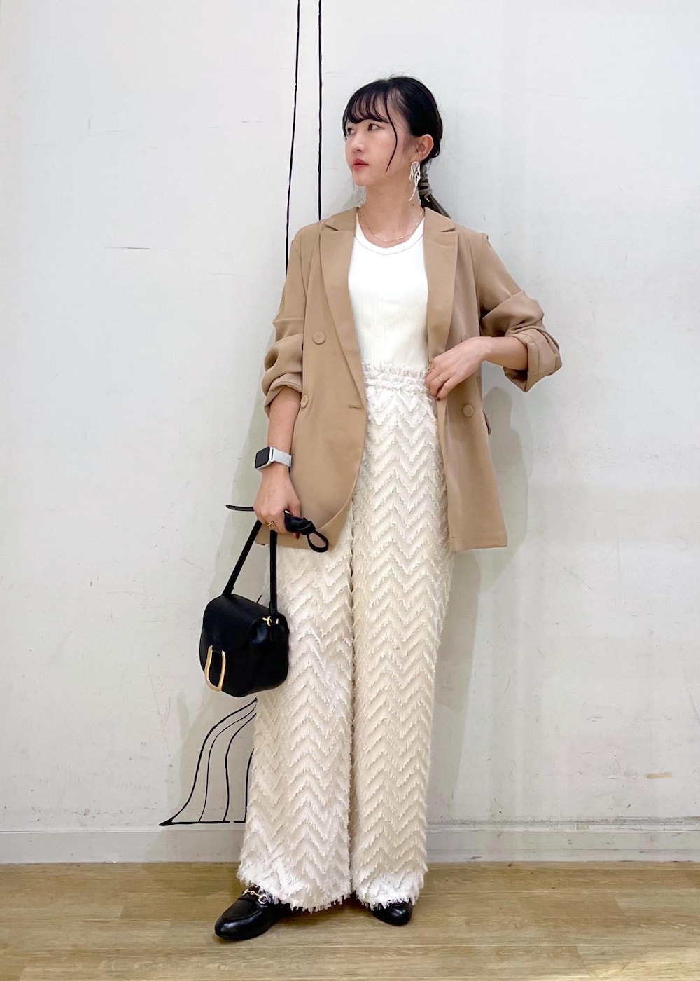 ベージュ系のタンクトップ、ブラック系のショルダーバッグ、ベージュ系のその他パンツを着用したレディースの秋コーディネートの2枚目の写真