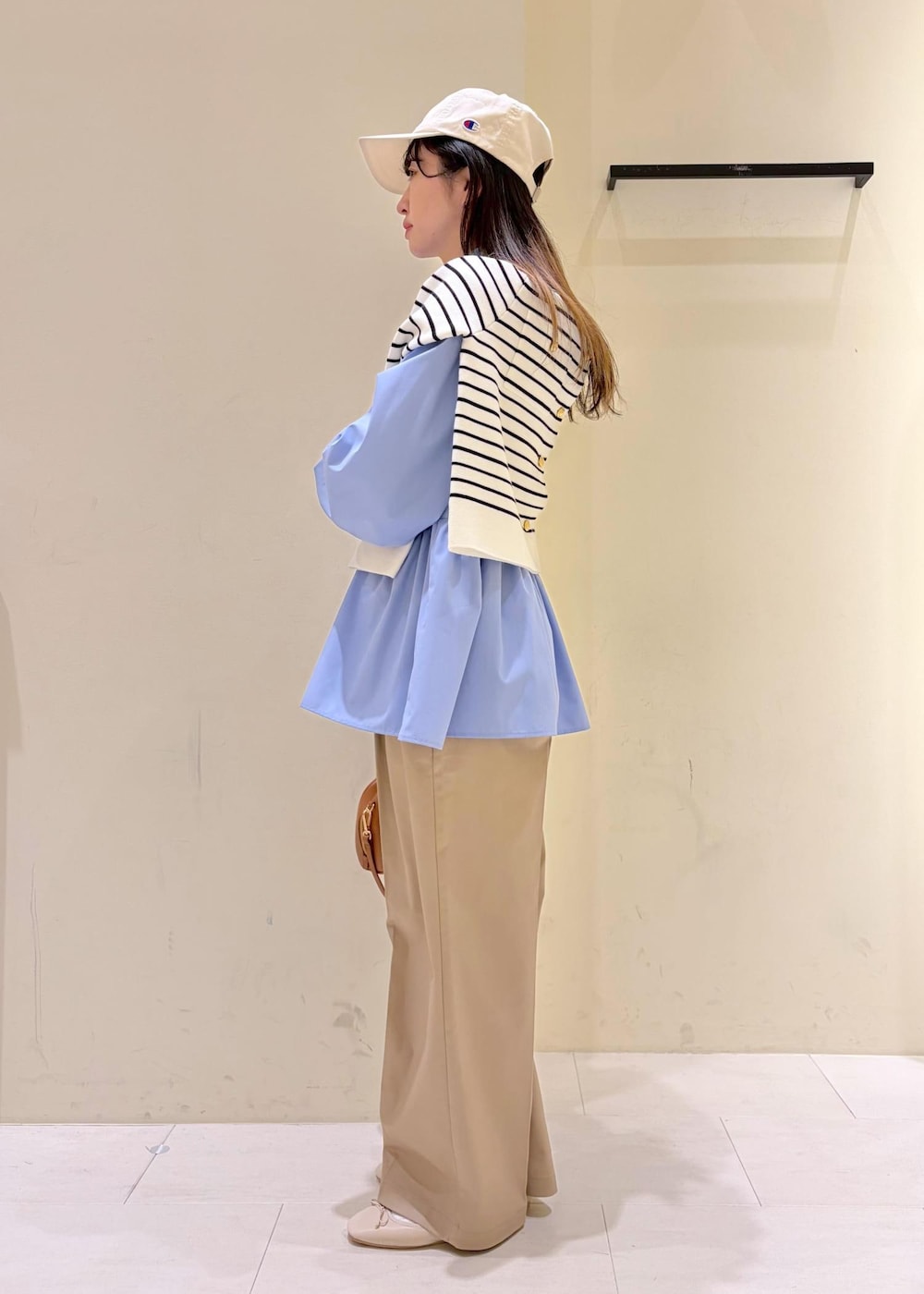 ホワイト系のバレエシューズ、イエロー系のショルダーバッグ、ベージュ系のチノパンツを着用したレディースの冬コーディネートの4枚目の写真