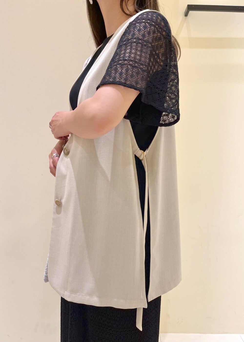 その他のショルダーバッグ、ベージュ系のベスト、ホワイト系のサンダルを着用したレディースの春コーディネートの6枚目の写真