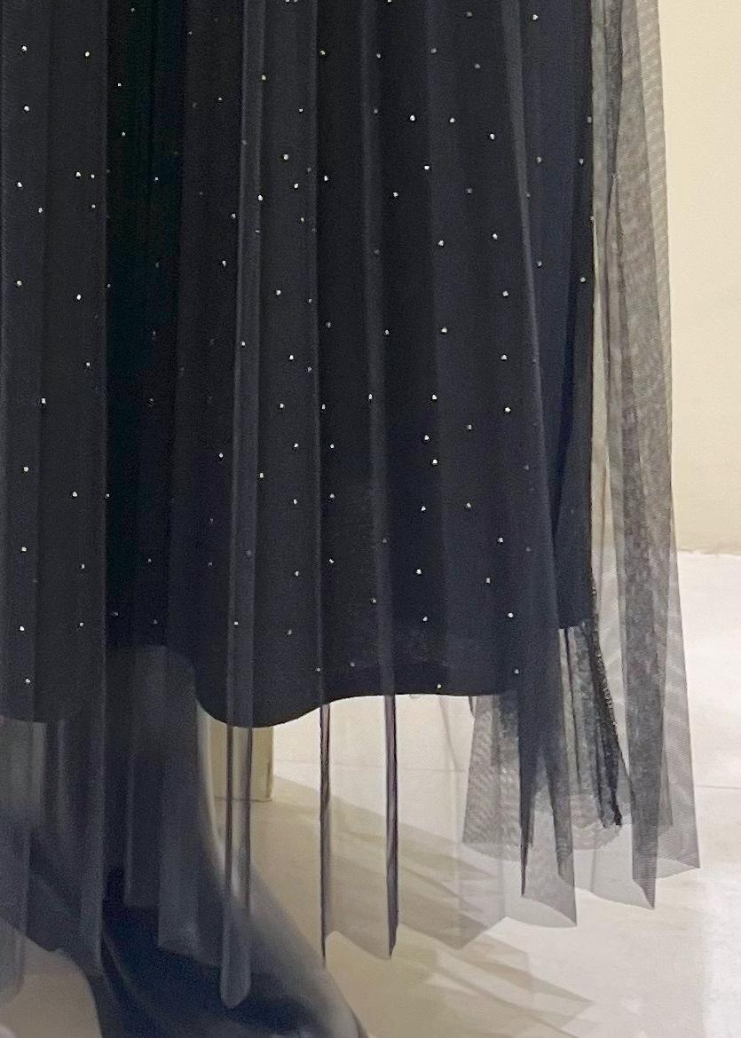 ホワイト系のショルダーバッグ、ブラック系のブーツ、ブラック系のスカートを着用したレディースの冬コーディネートの8枚目の写真