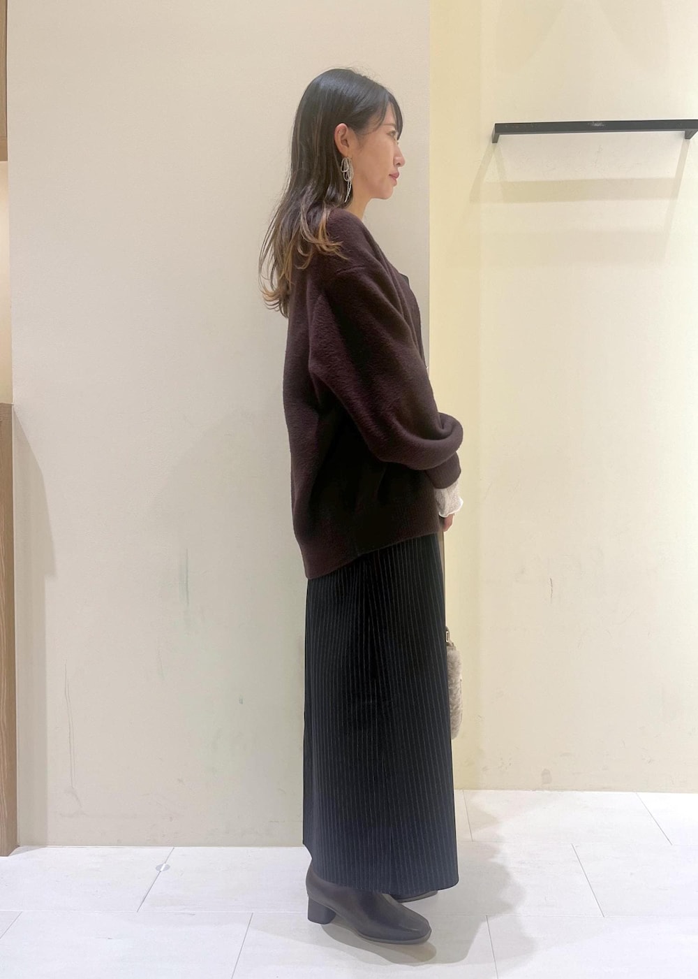 ブルー系のワンピース、ブラウン系のカーディガン/ボレロ、ホワイト系のTシャツ/カットソーを着用したレディースの秋コーディネートの2枚目の写真