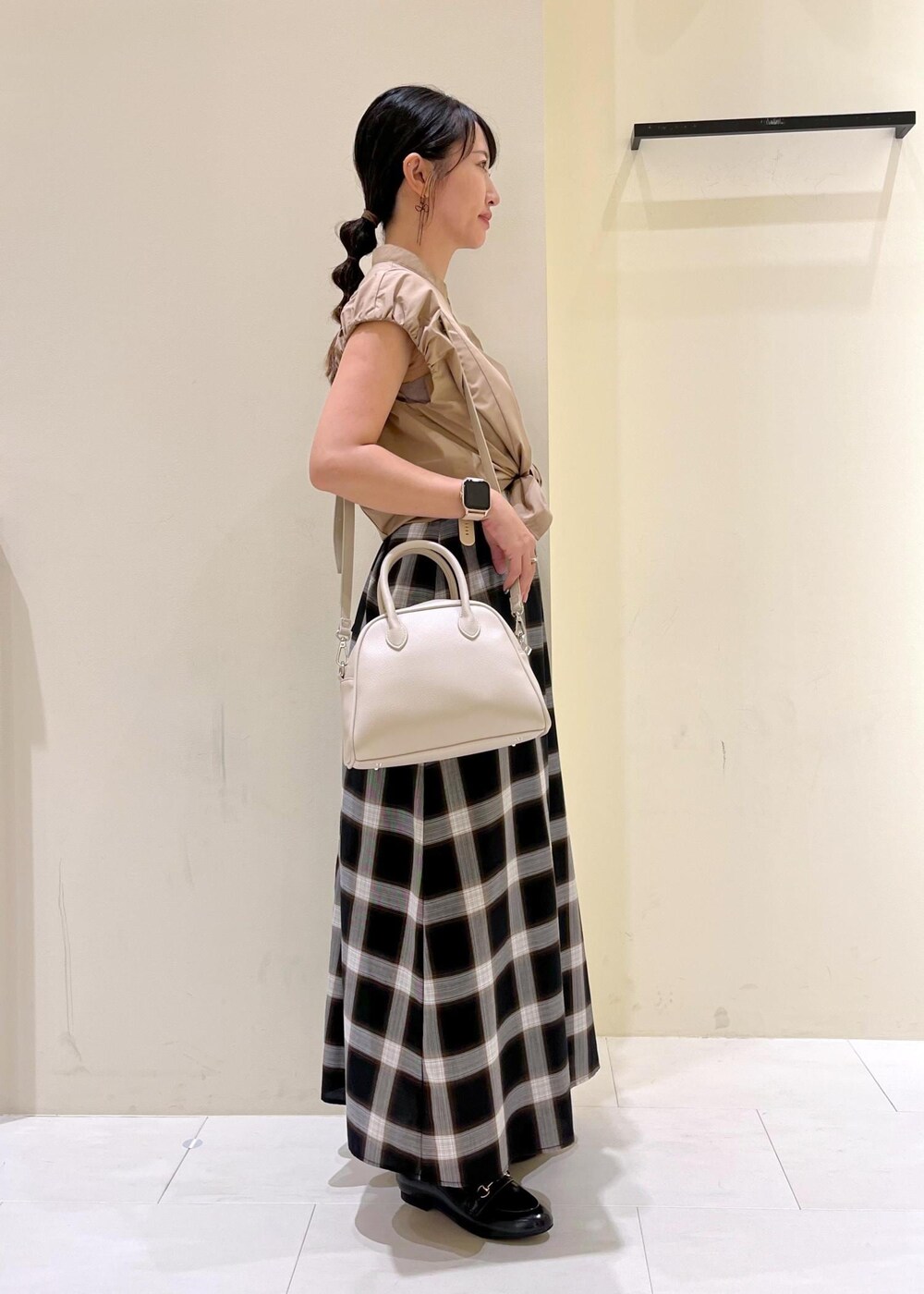 ブラック系のワンピース、イエロー系のシャツ/ブラウス、ブラック系のローファーを着用したレディースの夏コーディネートの3枚目の写真