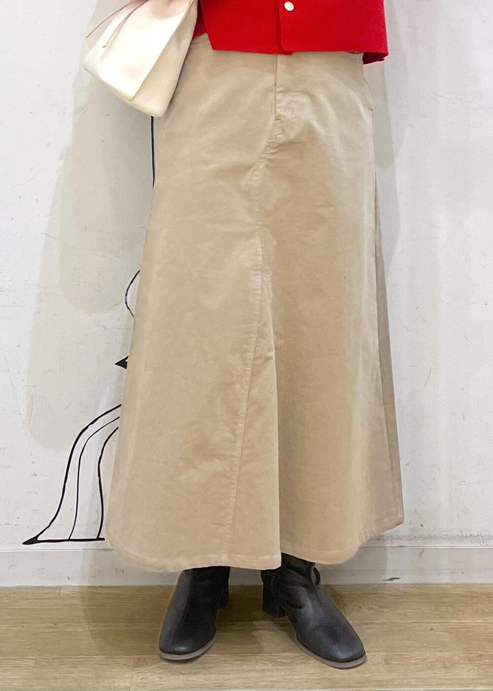 ブラック系のブーツ、ホワイト系のニット/セーター、レッド系のカーディガン/ボレロを着用したレディースの冬コーディネートの5枚目の写真