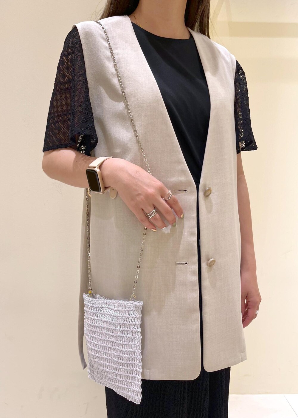 その他のショルダーバッグ、ベージュ系のベスト、ホワイト系のサンダルを着用したレディースの春コーディネートの5枚目の写真