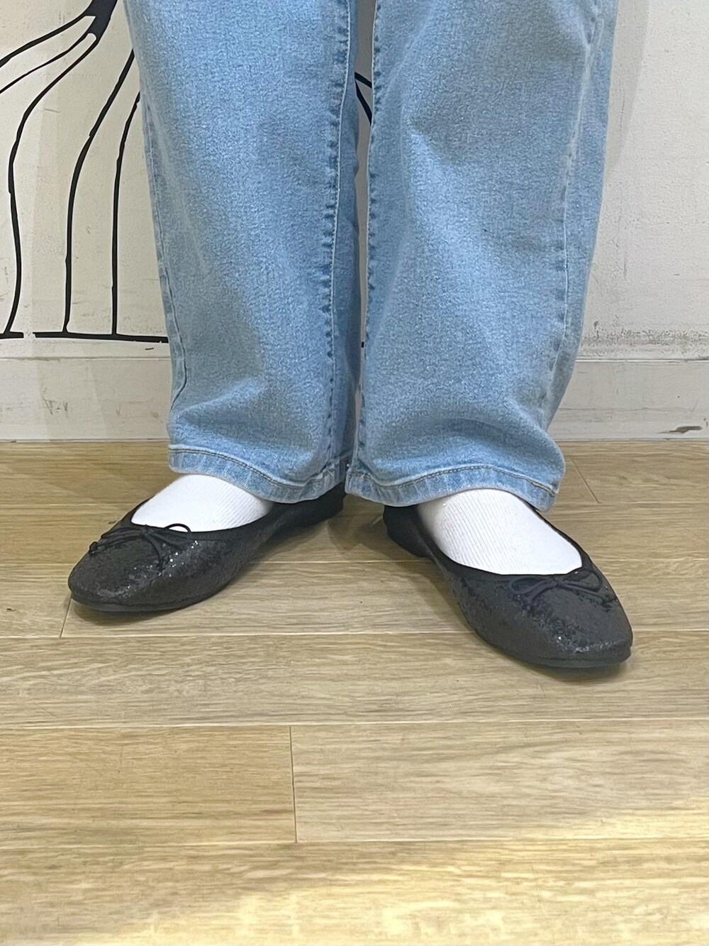 ブルー系のデニムパンツ、レッド系のトートバッグ、ブラック系のその他アウターを着用したレディースの冬コーディネートの10枚目の写真