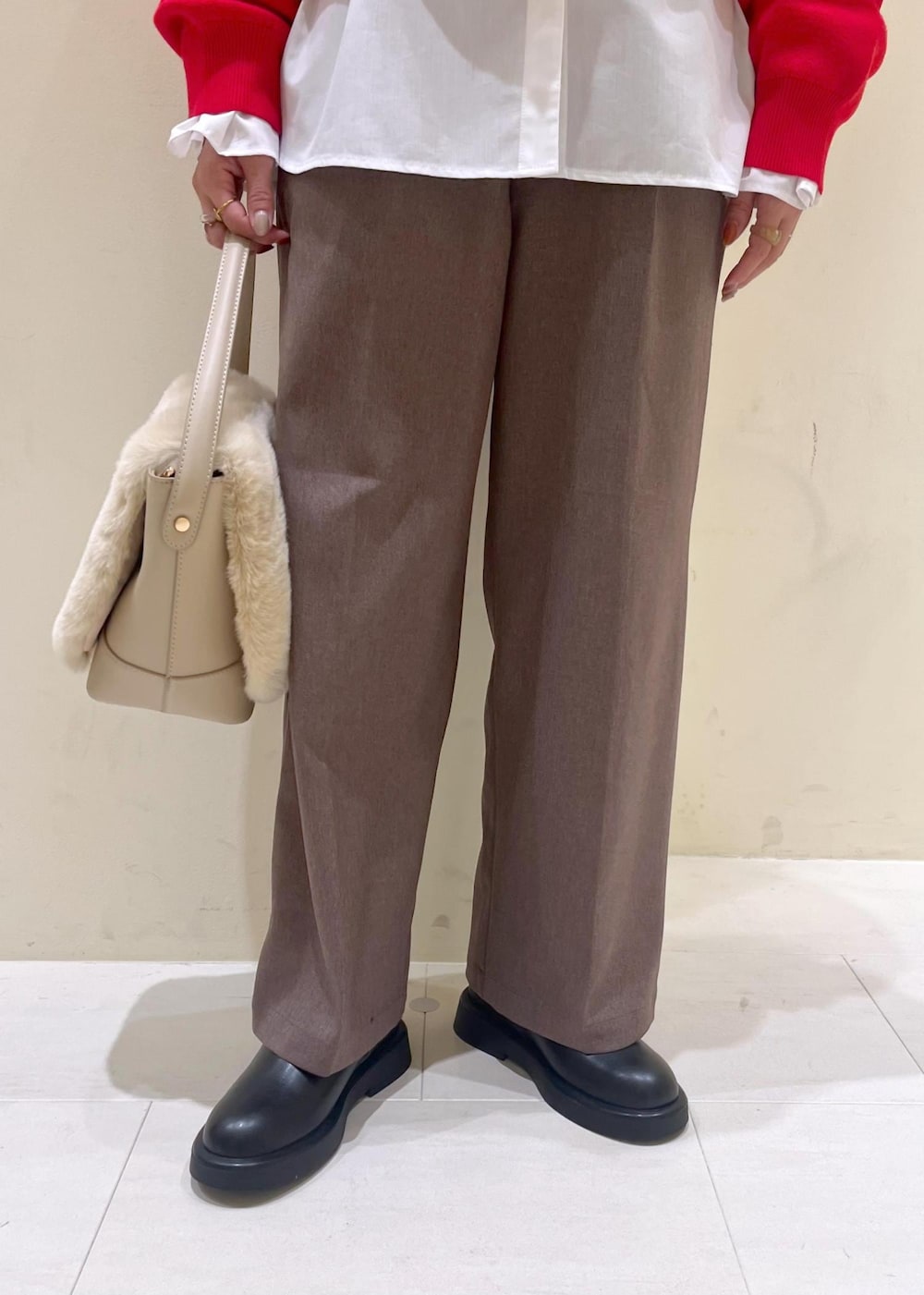 ベージュ系のスラックス、ホワイト系のシャツ/ブラウス、ブラック系のブーツを着用したレディースの冬コーディネートの8枚目の写真