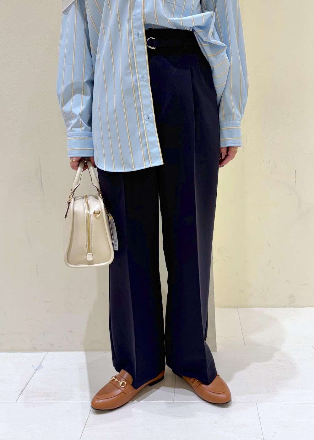 イエロー系のローファー、ホワイト系のボストンバッグ、ブルー系のその他パンツを着用したレディースの春コーディネートの8枚目の写真