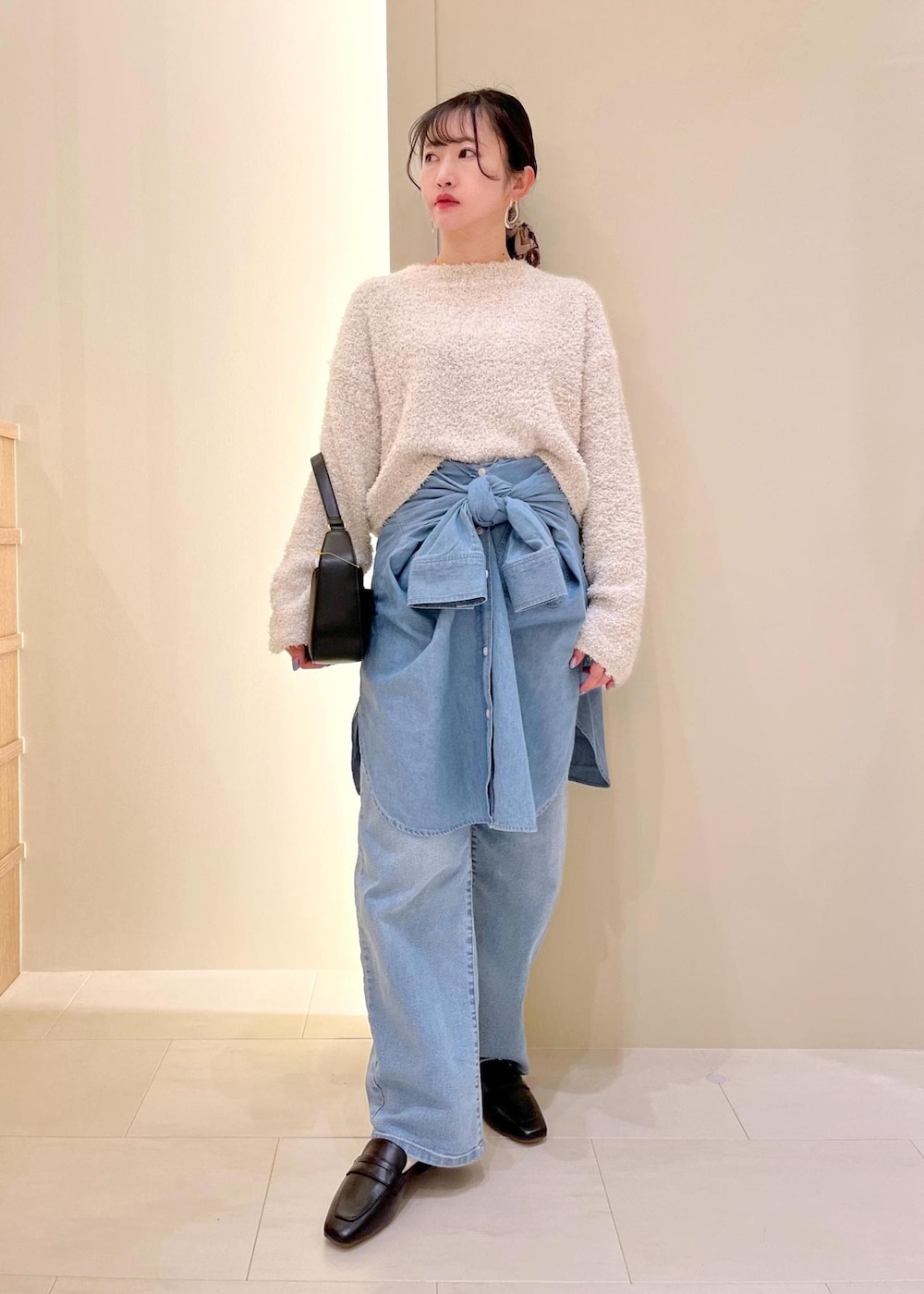 ブルー系のデニムパンツ、ブルー系のシャツ/ブラウス、グレー系のニット/セーターを着用したレディースの春コーディネートの2枚目の写真