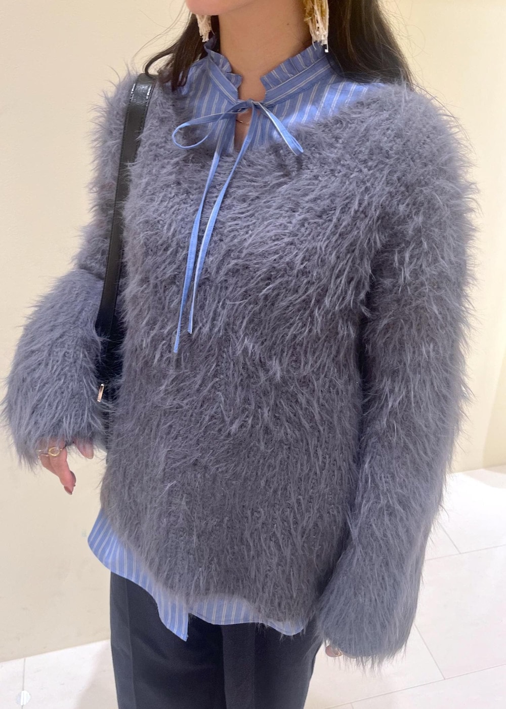 ブラック系のショルダーバッグ、ブルー系のその他パンツ、ブラック系のローファーを着用したレディースの冬コーディネートの5枚目の写真