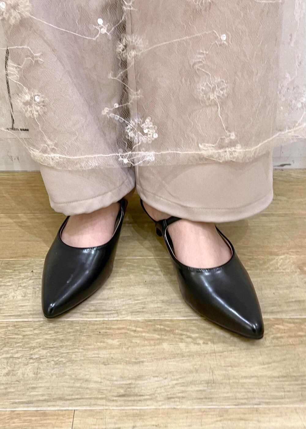 ブラック系のニット/セーター、ホワイト系のスカート、ブラック系のパンプスを着用したレディースの冬コーディネートの10枚目の写真