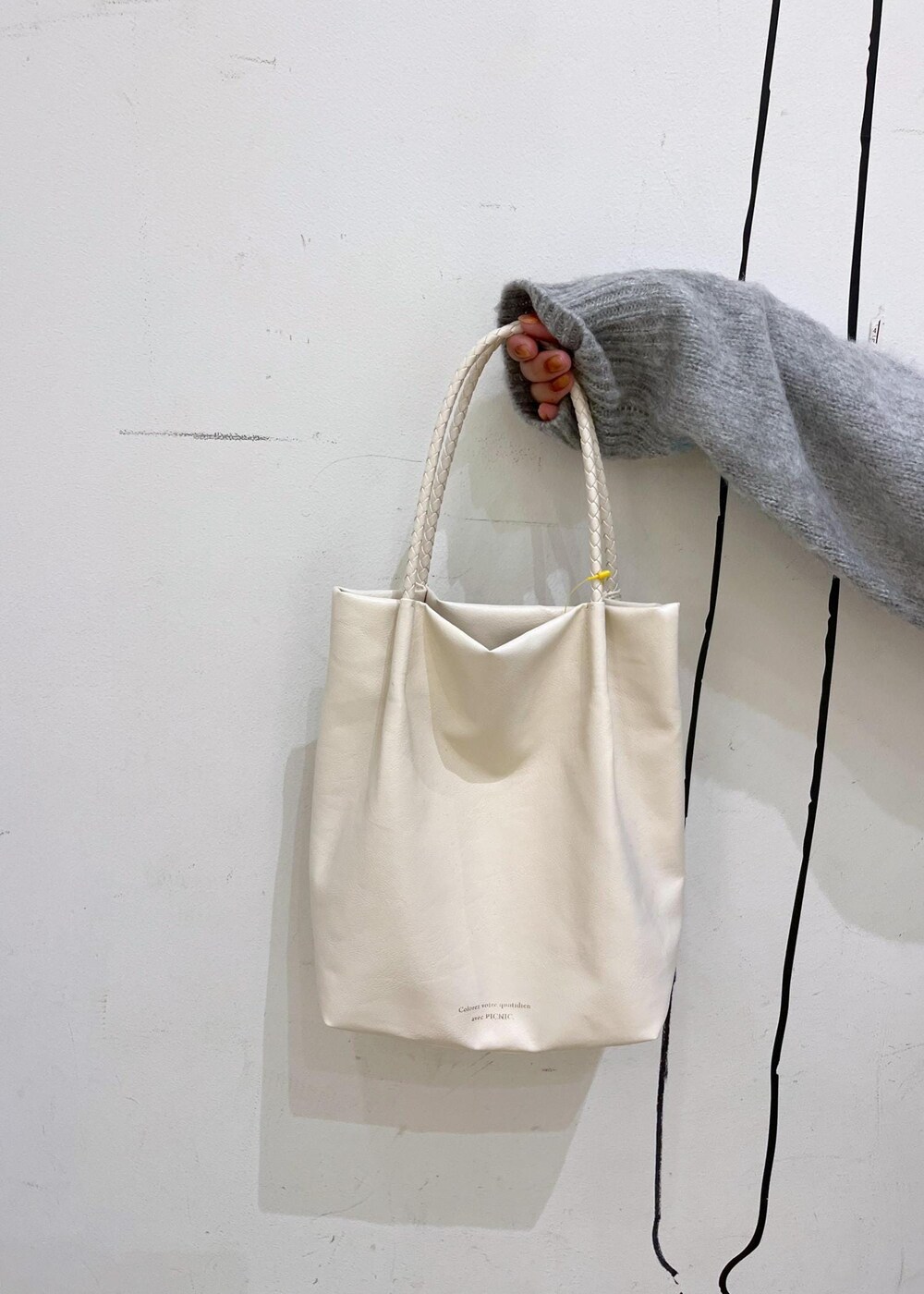 ブラック系のブーツ、ブルー系のニット/セーター、ブラウン系のスカートを着用したレディースの秋コーディネートの9枚目の写真