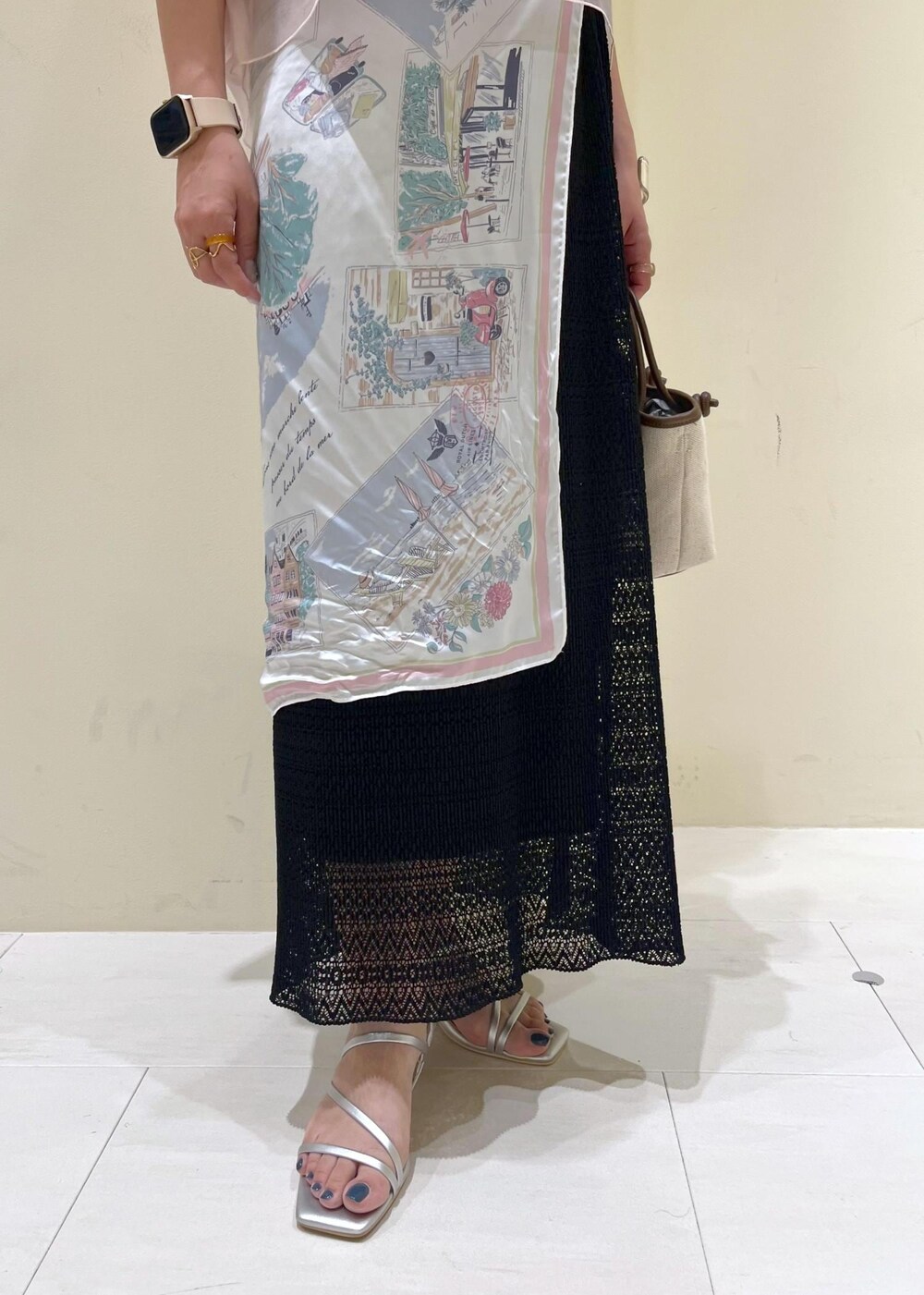 シルバー系のサンダル、ブラウン系のトートバッグ、ブラック系のスカートを着用したレディースの夏コーディネートの6枚目の写真