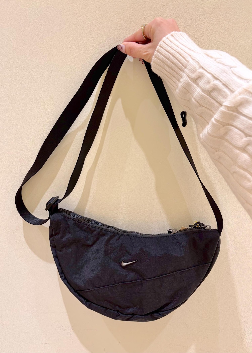 ホワイト系のニット/セーター、ベージュ系のその他パンツ、ブラック系のボディバッグ/ウエストポーチを着用したレディースの冬コーディネートの9枚目の写真