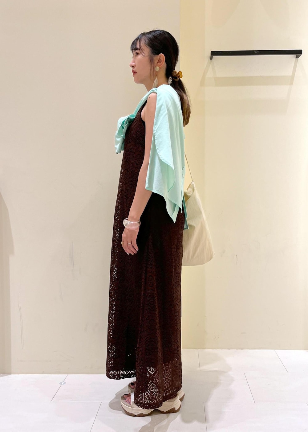 ブラック系のタンクトップ、グリーン系のシャツ/ブラウス、ホワイト系のトートバッグを着用したレディースの夏コーディネートの6枚目の写真