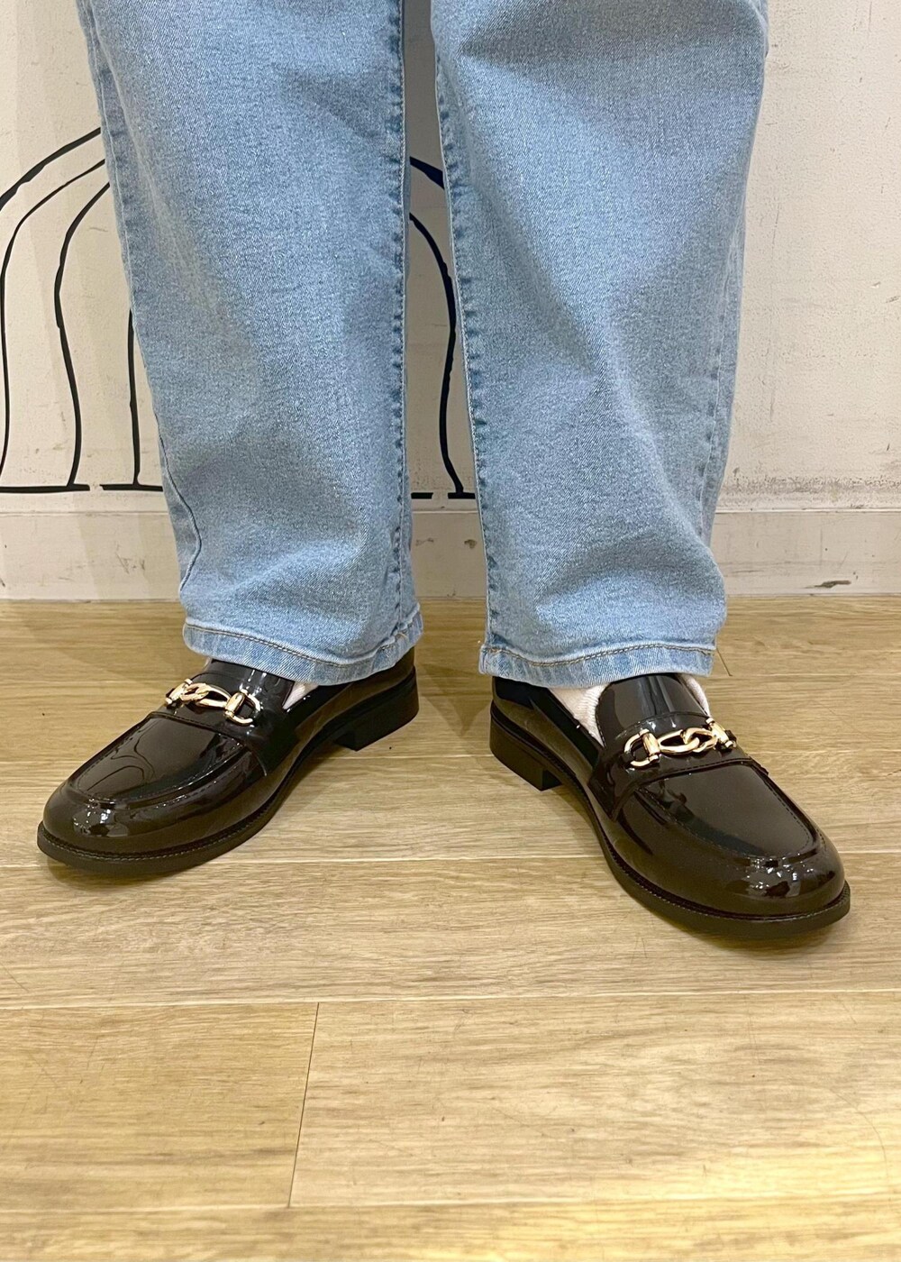 ホワイト系のニット/セーター、ブルー系のデニムパンツ、ブラック系のレインシューズを着用したレディースの冬コーディネートの10枚目の写真