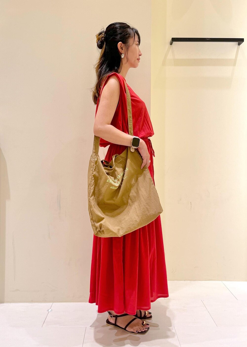 ブラウン系のサンダル、レッド系のワンピース、ブラウン系のトートバッグを着用したレディースの夏コーディネートの2枚目の写真