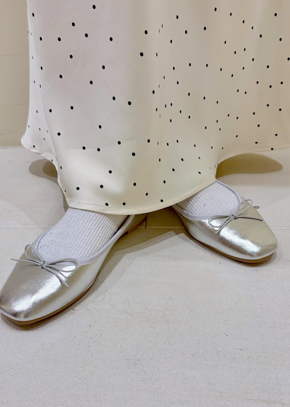 ベージュ系のボストンバッグ、ブルー系のTシャツ/カットソー、ベージュ系のベストを着用したレディースの春コーディネートの10枚目の写真