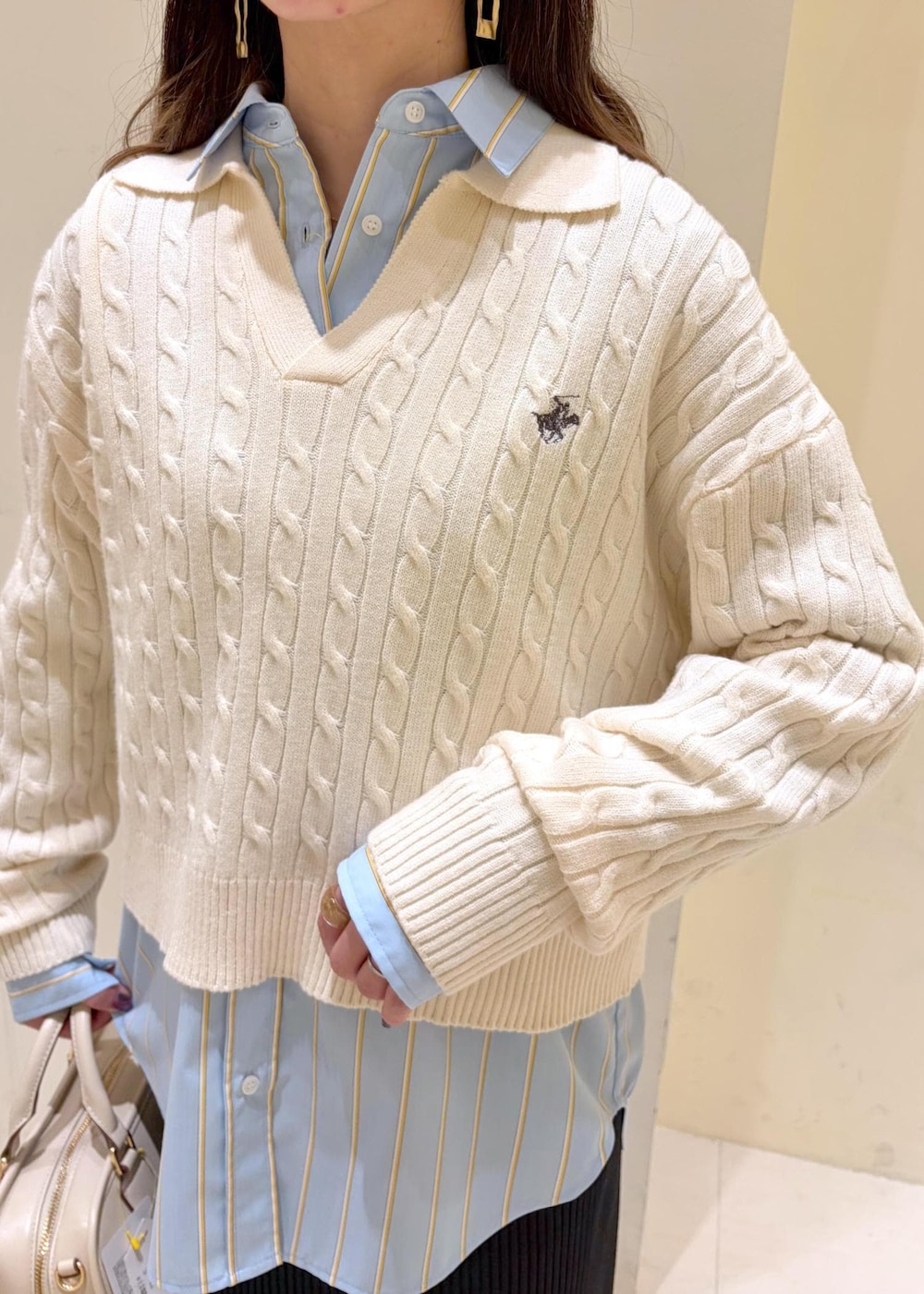 ホワイト系のニット/セーター、ブラック系のローファー、ホワイト系のボストンバッグを着用したレディースの冬コーディネートの5枚目の写真