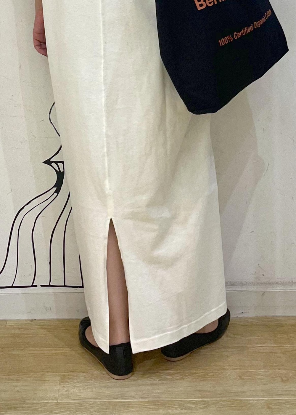 ブラック系のトートバッグ、ブラック系のバレエシューズ、ホワイト系のワンピースを着用したレディースの夏コーディネートの9枚目の写真