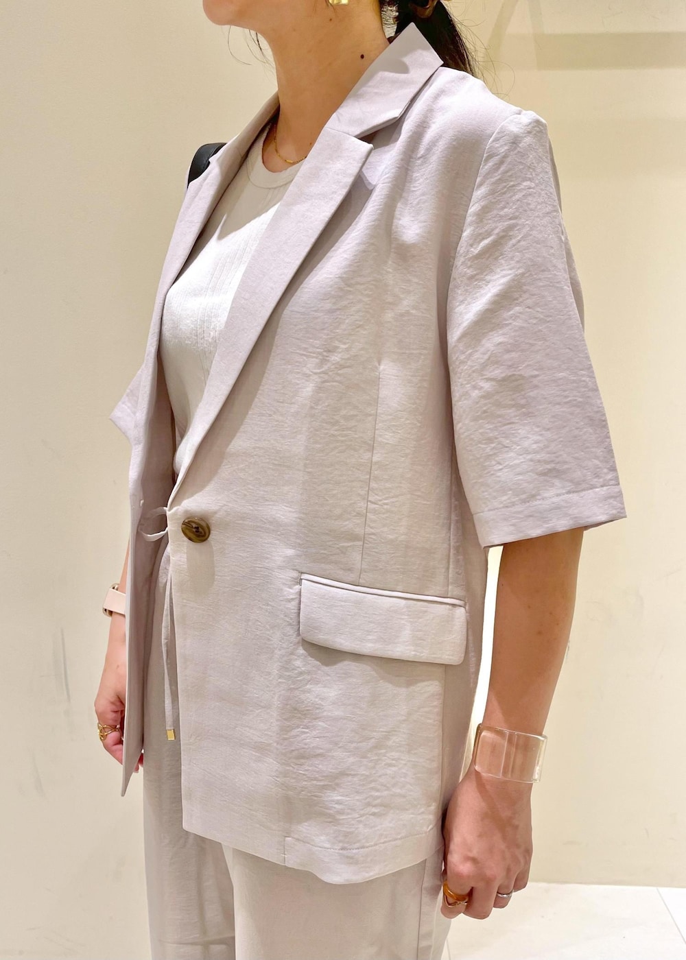 ベージュ系のタンクトップ、ベージュ系のその他パンツ、ベージュ系のテーラードジャケットを着用したレディースの夏コーディネートの5枚目の写真