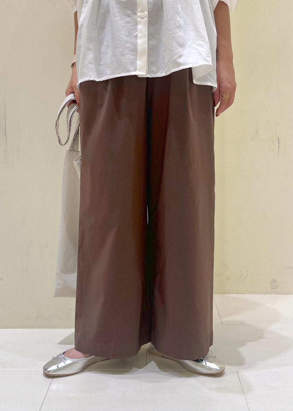 シルバー系のバレエシューズ、ブラウン系のその他パンツ、ホワイト系のシャツ/ブラウスを着用したレディースの秋コーディネートの7枚目の写真