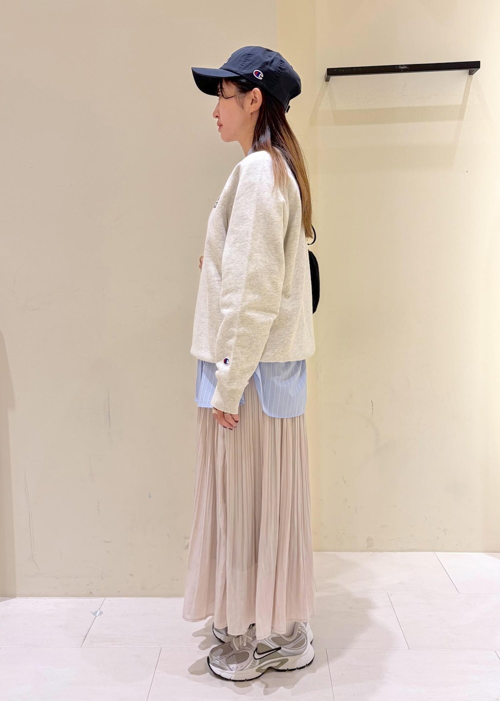 ホワイト系のスウェット、ブルー系のシャツ/ブラウス、ベージュ系のスカートを着用したレディースの冬コーディネートの4枚目の写真