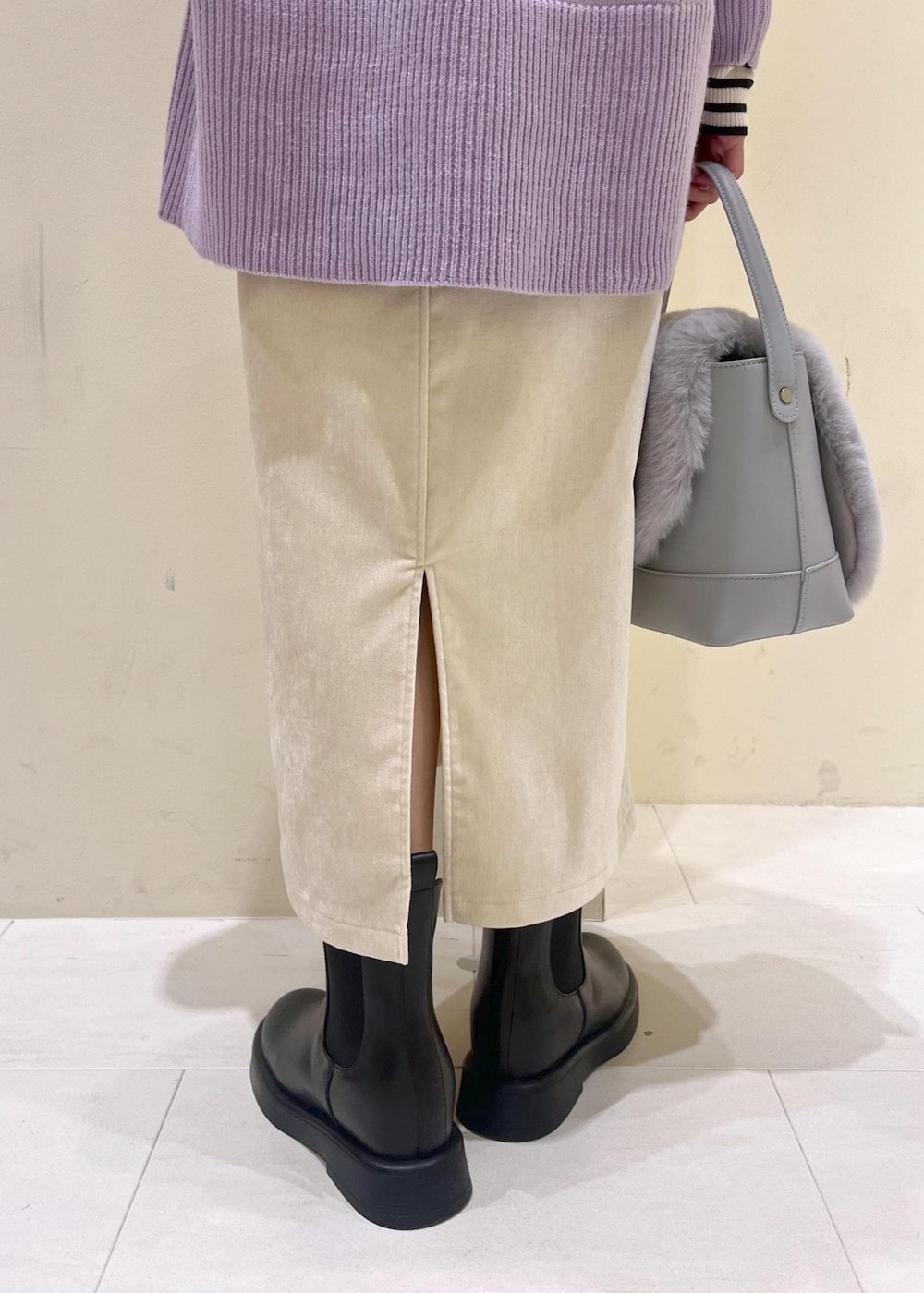 ホワイト系のスカート、パープル系のニット/セーター、ホワイト系のニット/セーターを着用したレディースの冬コーディネートの8枚目の写真