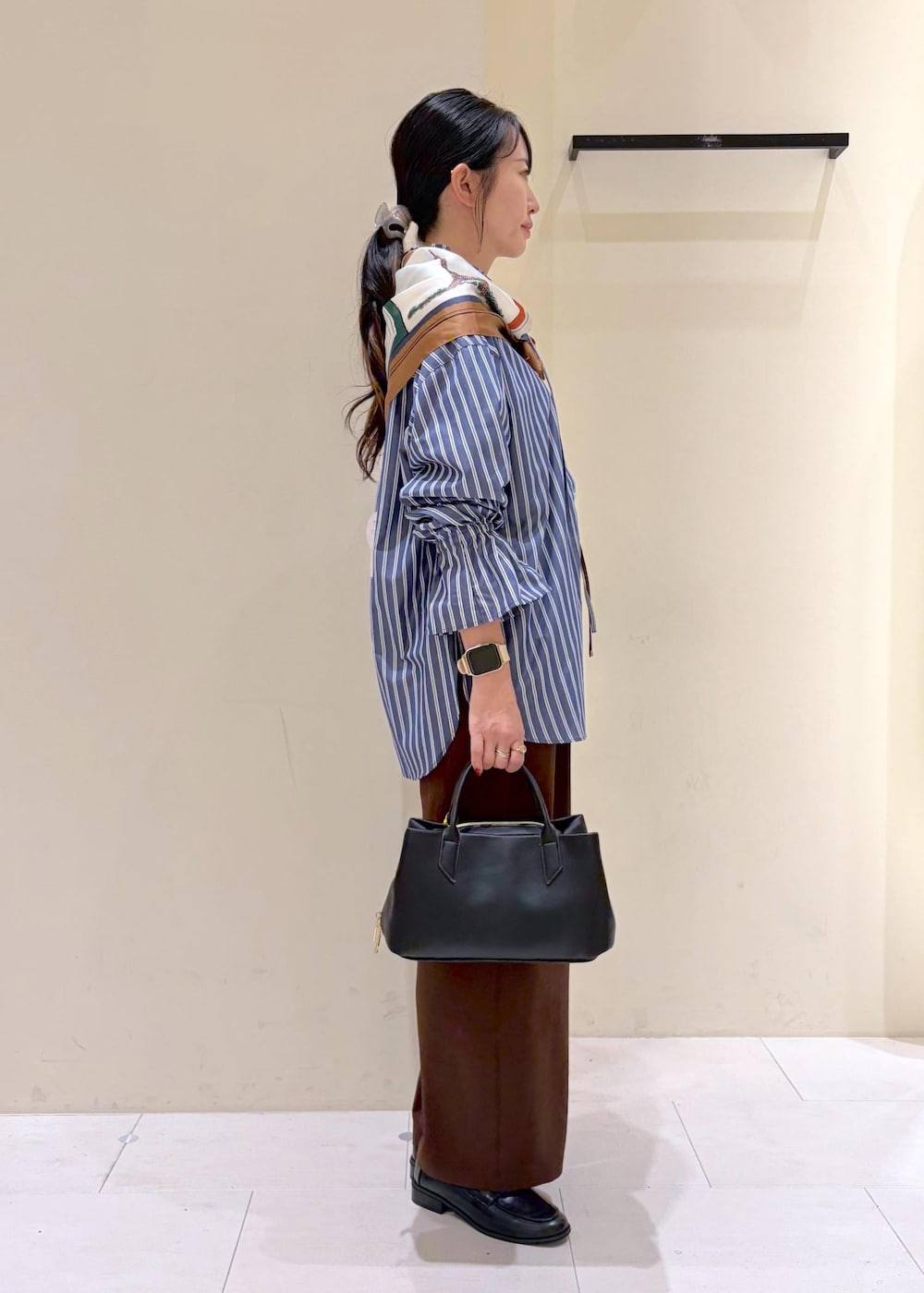 ブラウン系のその他パンツ、ブルー系のシャツ/ブラウス、ブラック系のローファーを着用したレディースの秋コーディネートの3枚目の写真